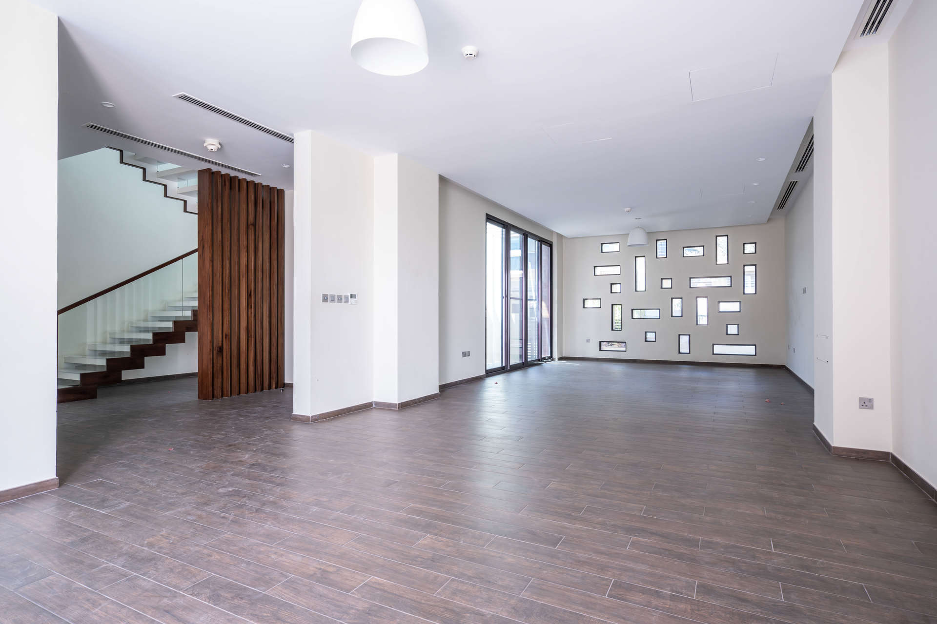 Modern kitchen interior in 4-bedroom villa, Umm Suqeim 2, with large windows and island