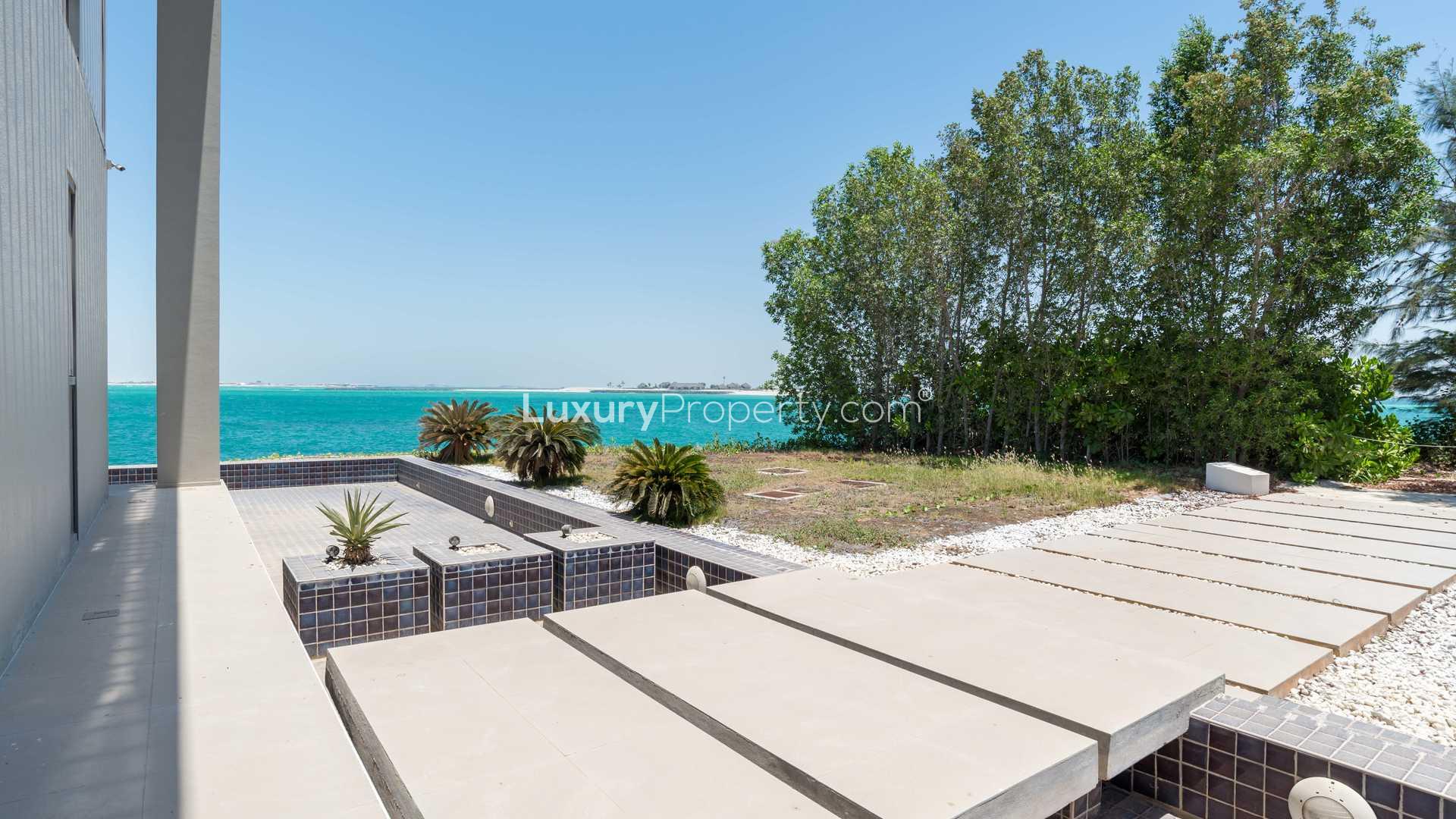 "Beachfront villa patio with ocean view on Zaya Nurai Island, Water Villa for sale.",Majestic beachfront villa deck overlooking ocean on Zaya Nurai Island, Water Villas