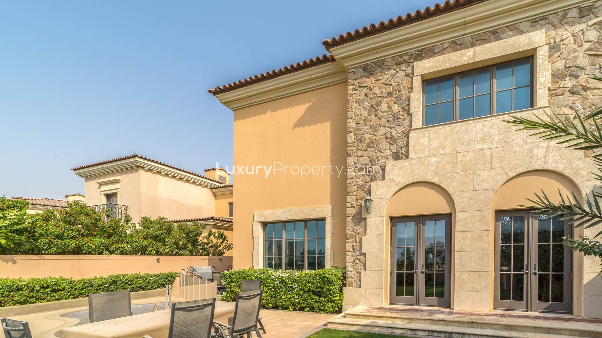 Luxurious bathroom in Whispering Pines villa, Jumeirah Golf Estates, featuring wooden cabinets