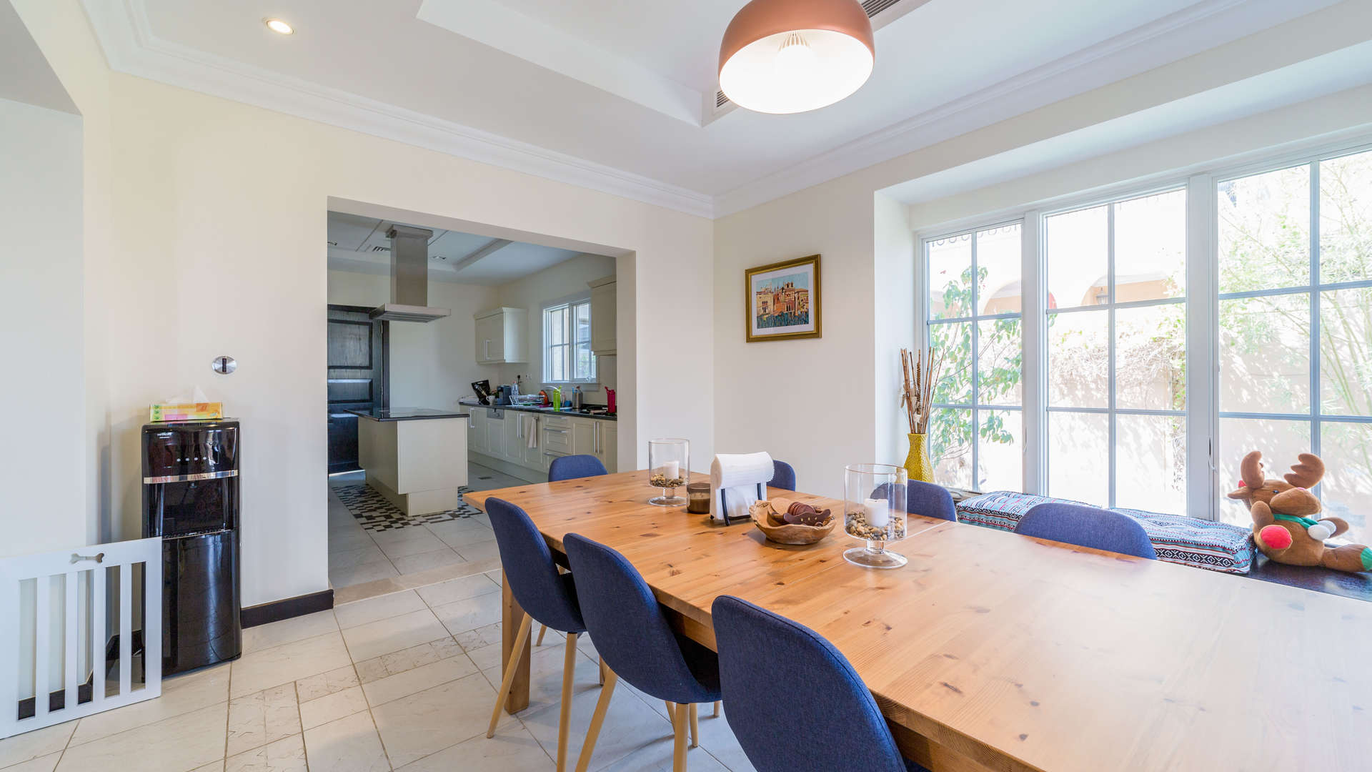 "Spacious terrace view at Whispering Pines villa, Jumeirah Golf Estates, Earth community.",Dining area with wooden table and large windows in Whispering Pines villa, Jumeirah Golf Estates