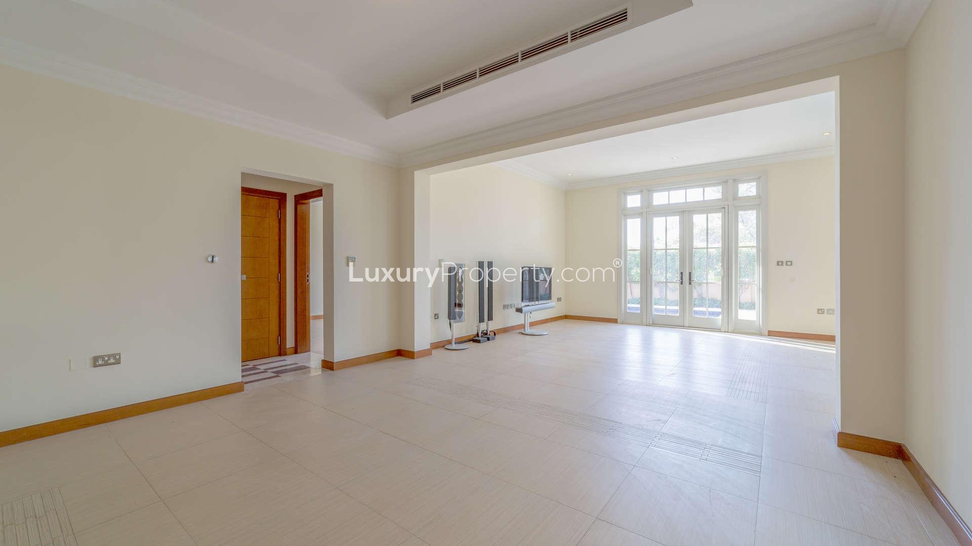 "Bright room with large windows in Jumeirah Golf Estates villa for sale.",Spacious living room with natural light, villa for sale in Jumeirah Golf Estates, Earth
