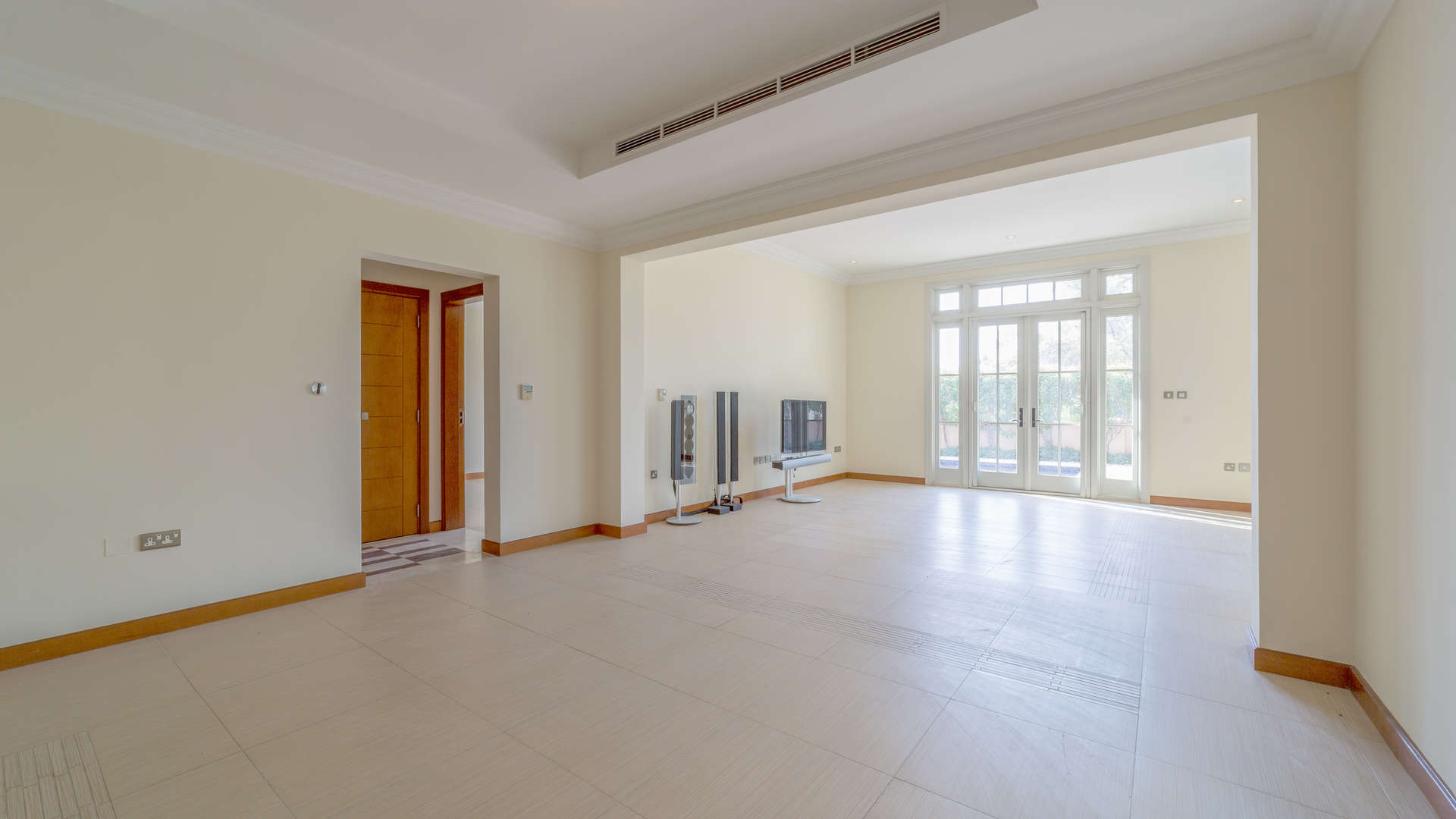 "Bright room with large windows in Jumeirah Golf Estates villa for sale.",Spacious living room with natural light, villa for sale in Jumeirah Golf Estates, Earth
