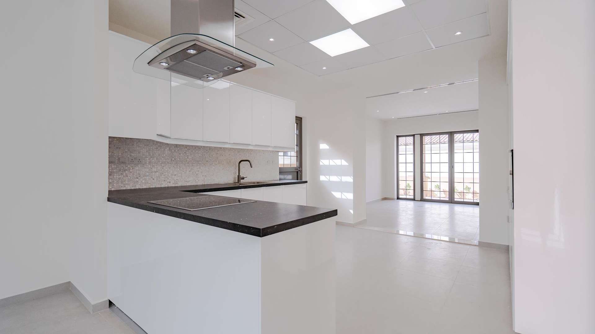 Spacious living area with large windows in 4-bedroom villa, Whispering Pines, Jumeirah Golf Estates