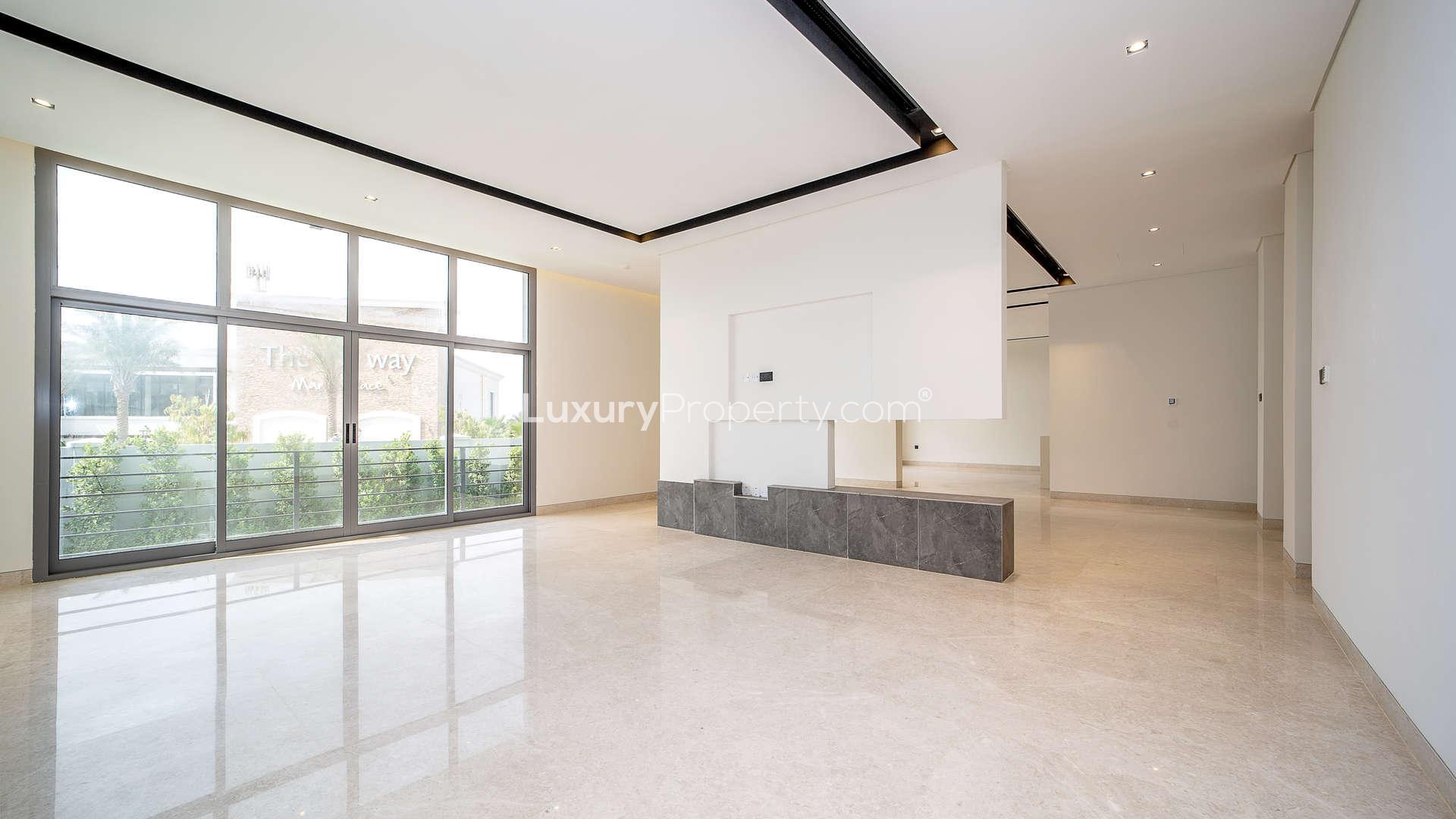 Modern kitchen with island and large windows in Wildflower villa, Jumeirah Golf Estates