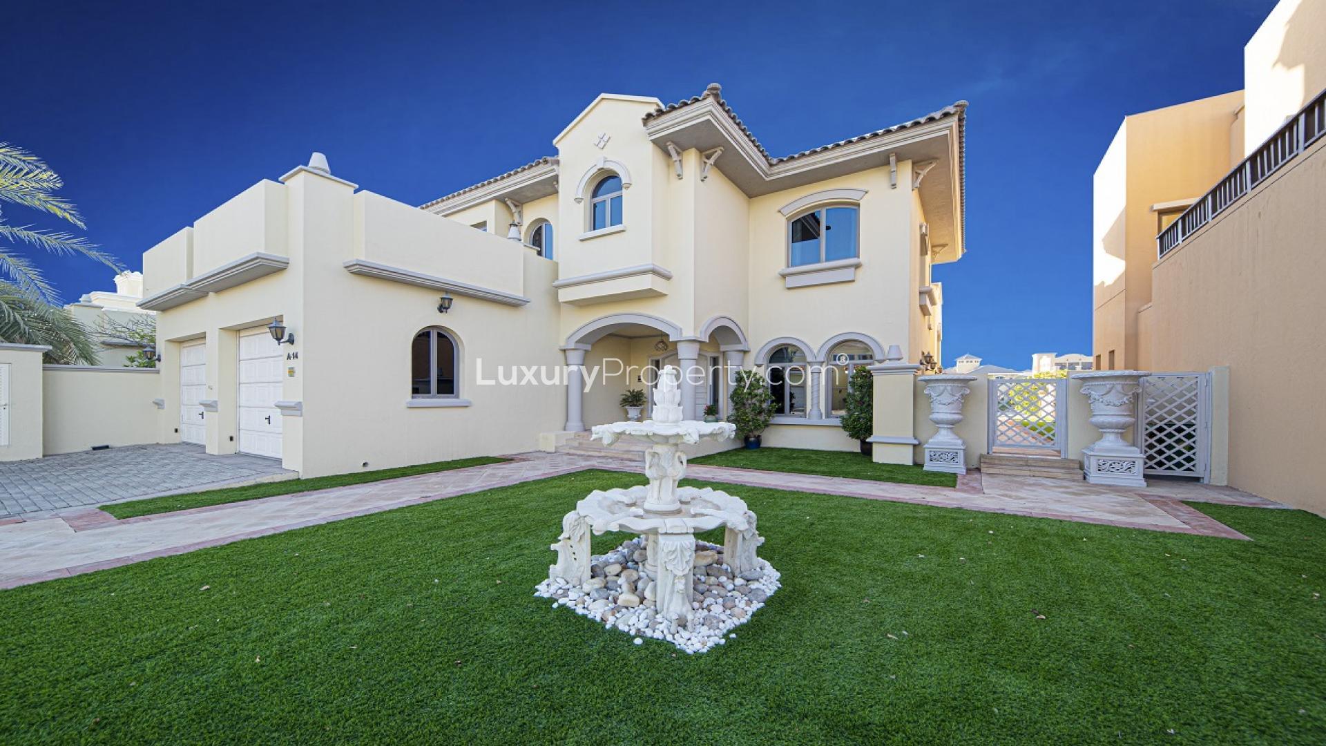 Luxurious living room in Palm Jumeirah villa with pool view and elegant furnishings