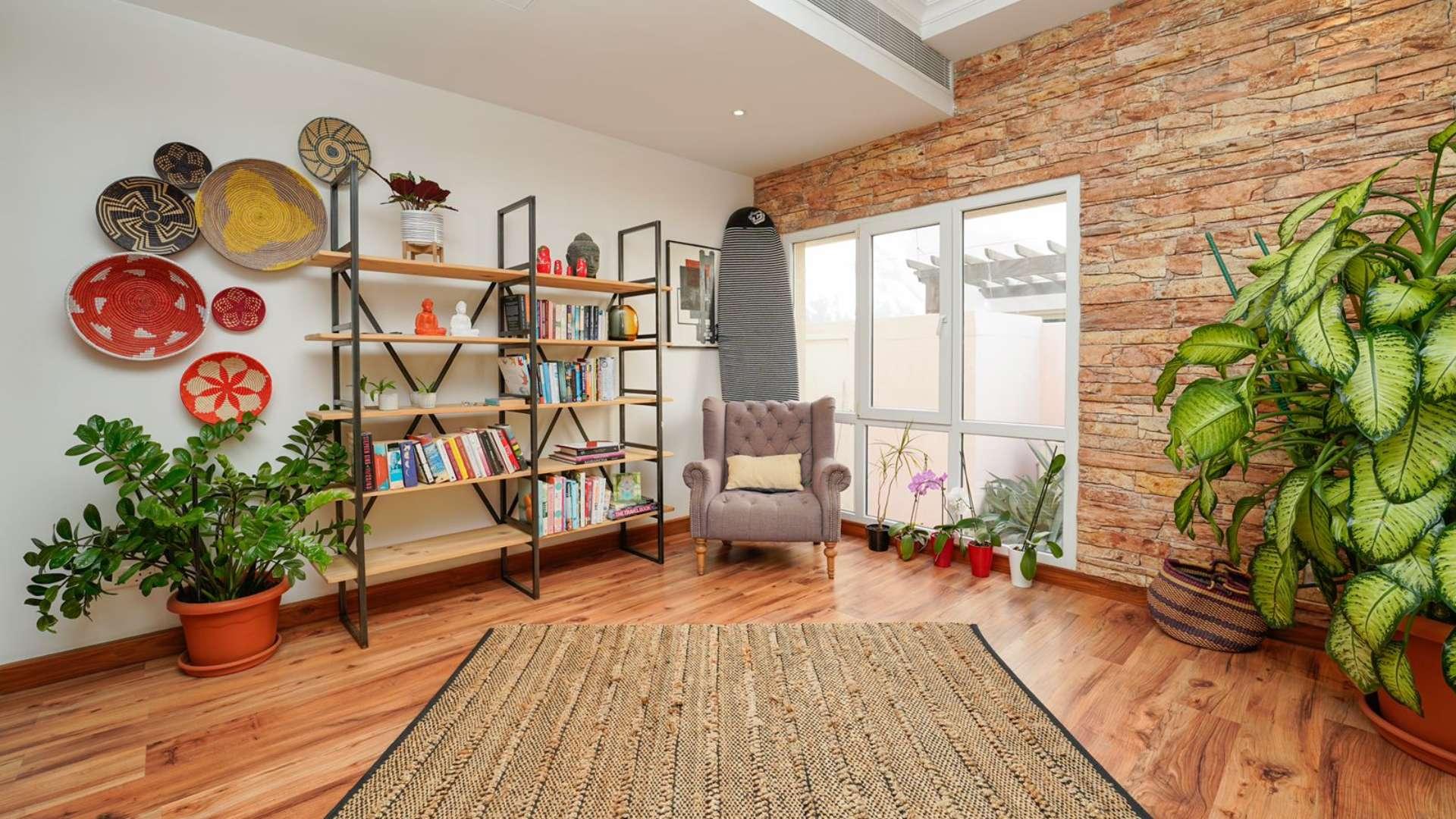 Contemporary living room in Meadows 6 villa with stylish decor and brick accent wall