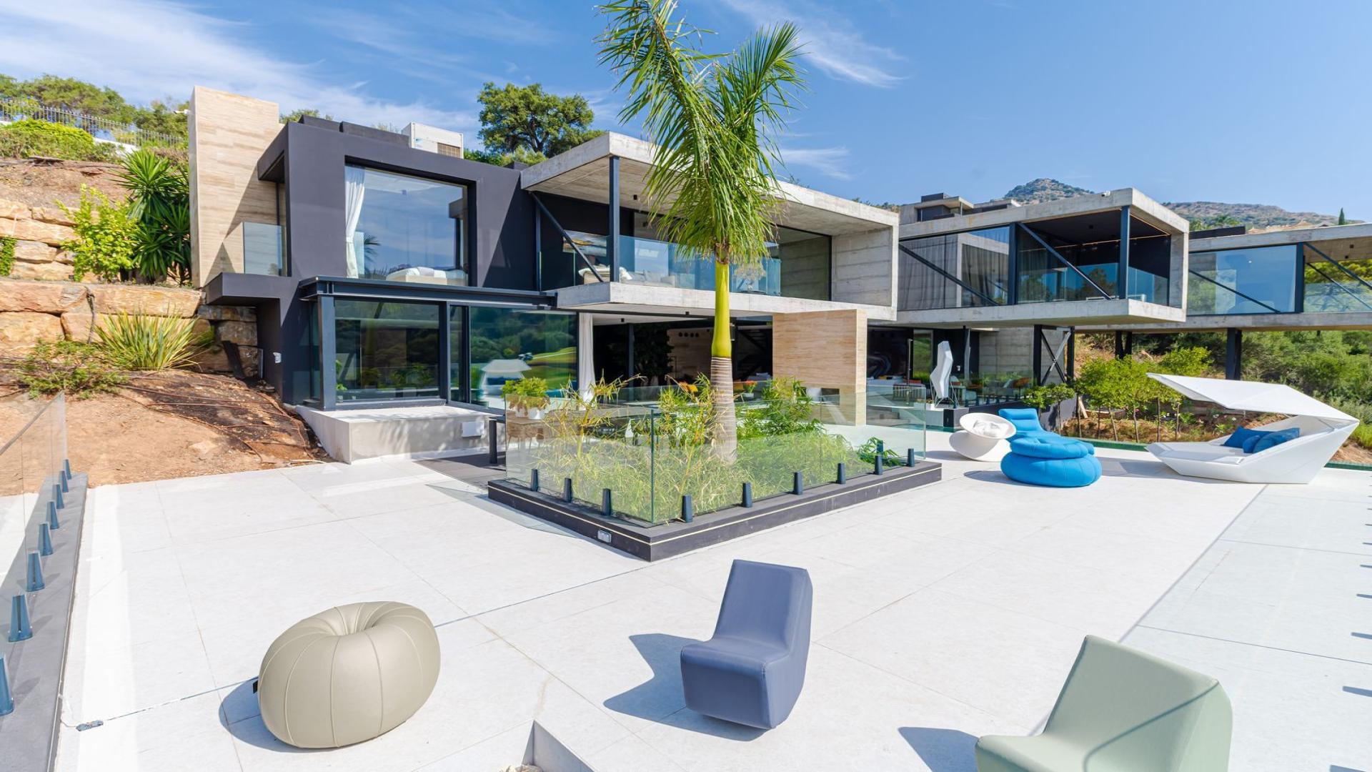 Luxury villa terrace with infinity pool overlooking Marbella Club Golf Resort in Benahavis