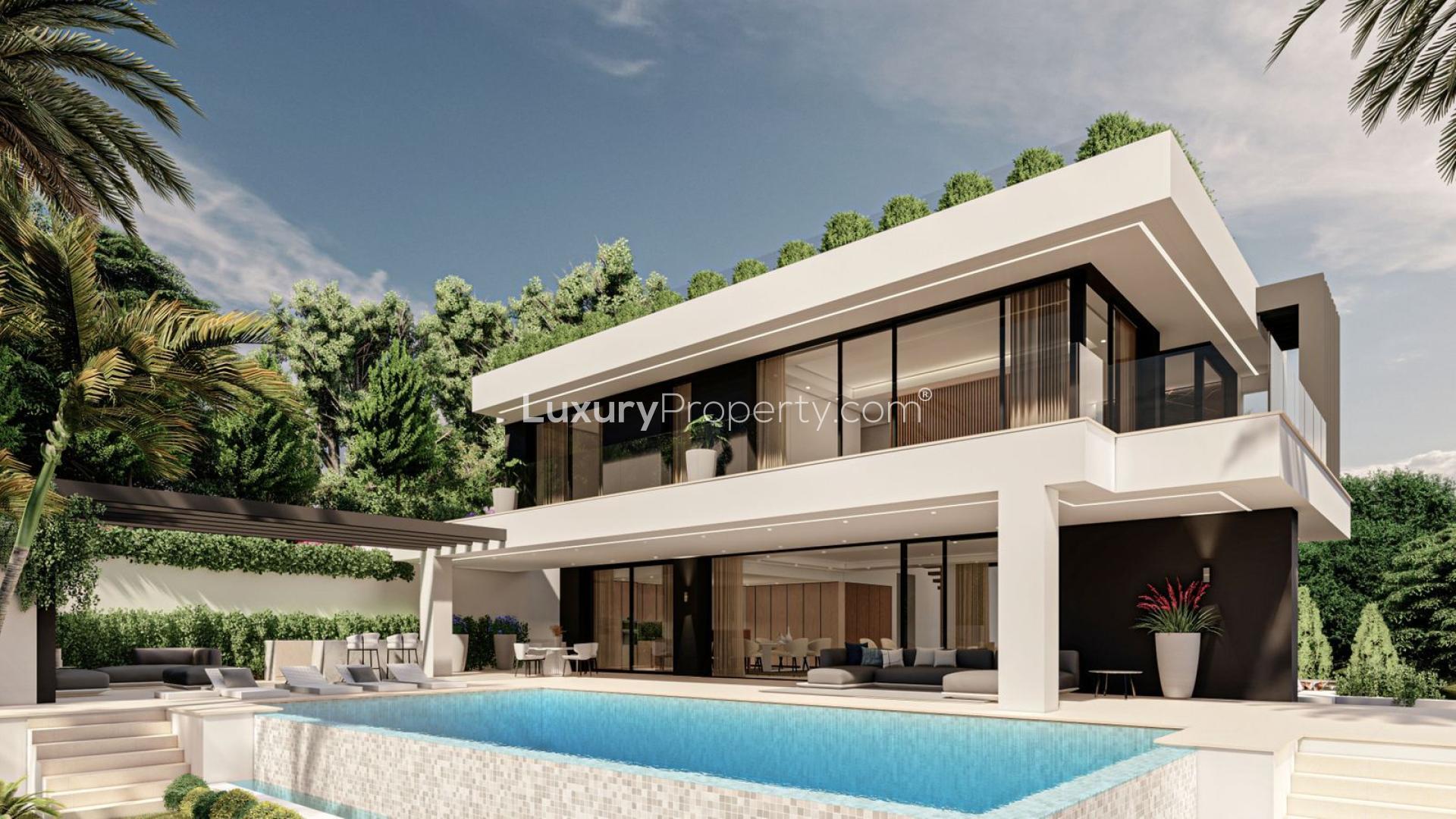 Modern luxury villa with pool in Marbella Golden Mile, surrounded by lush greenery