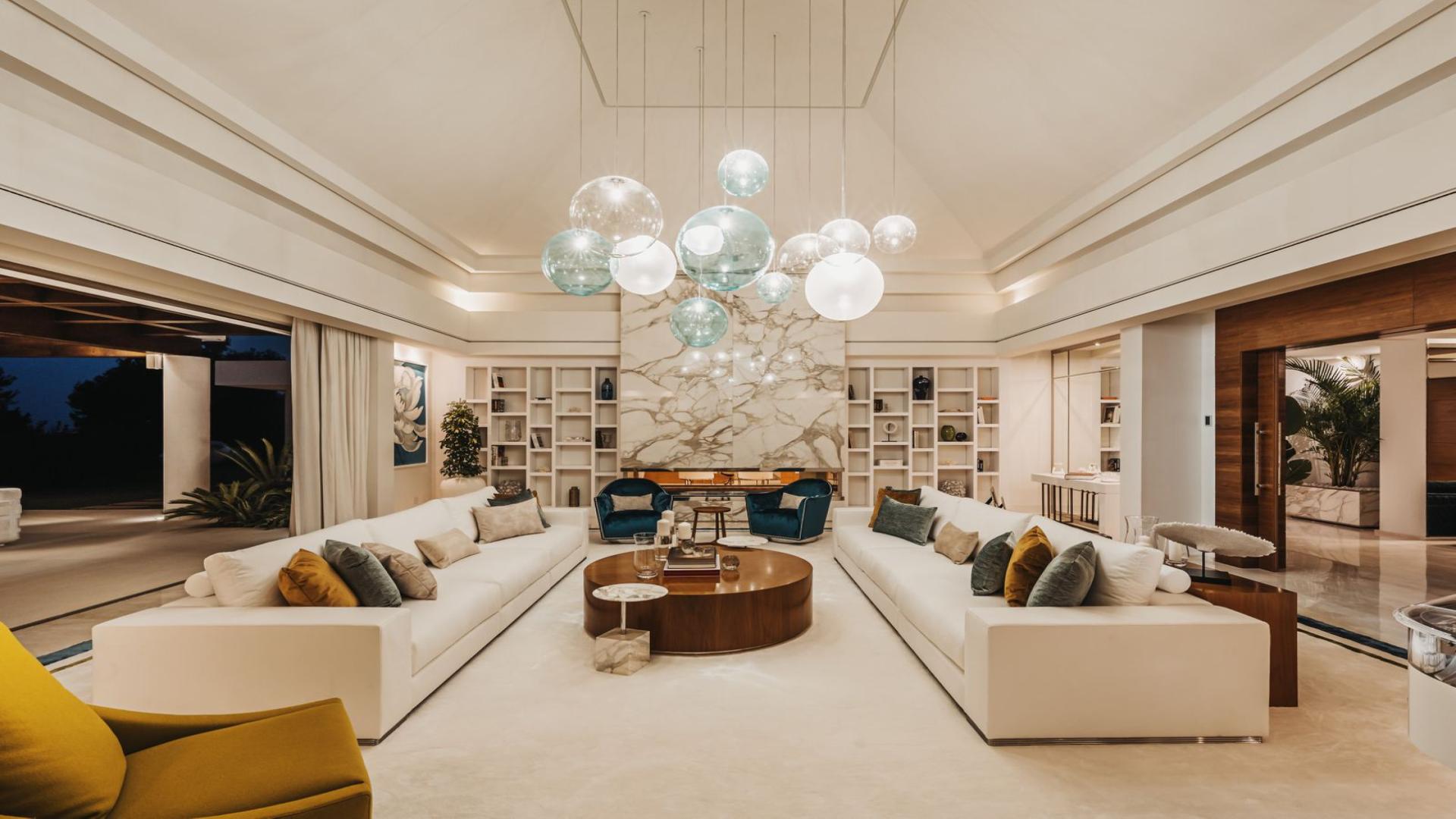 Luxurious living room in Marbella villa with modern decor and garden view