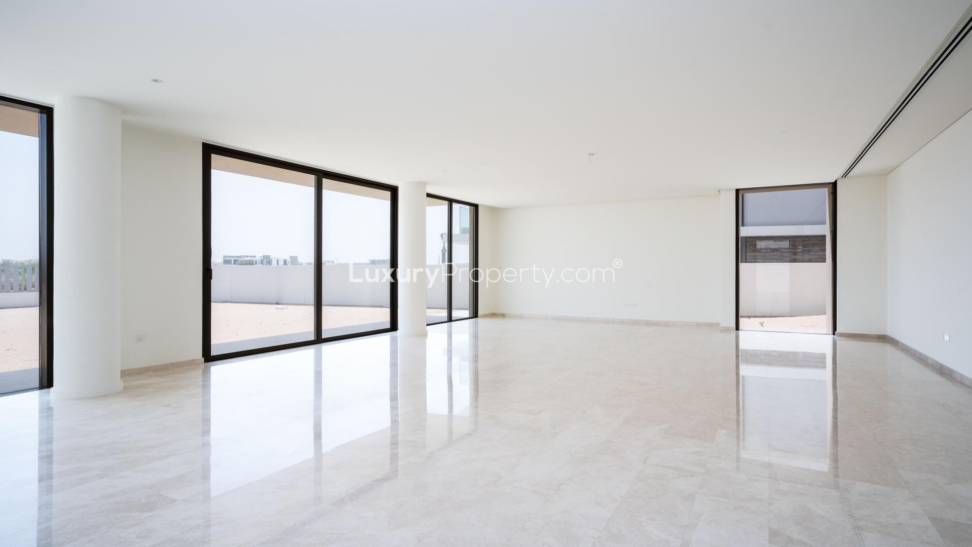 Spacious living area in Dubai Hills Estate villa with large windows and marble flooring