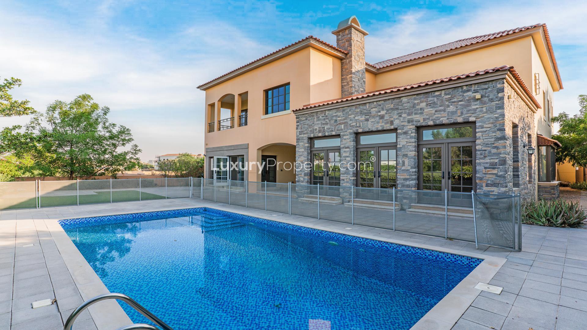 Bright living room with large windows in Jumeirah Golf Estates villa for rent