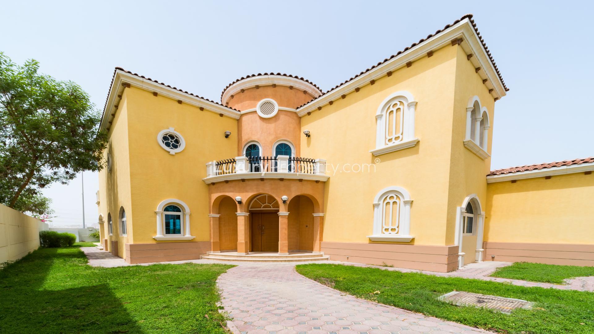 Spacious living area in five-bedroom Legacy Villa, Jumeirah Park, with large windows and staircase