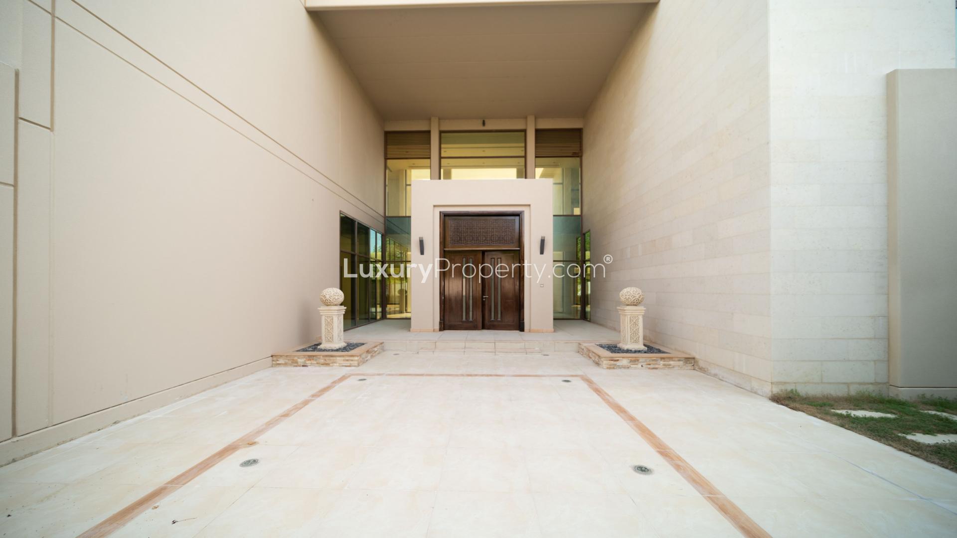 Exterior view of Meydan villa with landscaped garden and large windows for rent