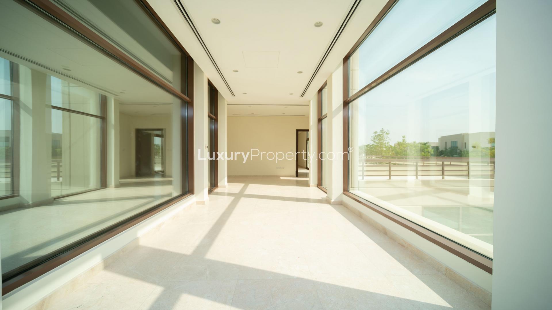 Bright spacious living room with large windows in Meydan villa for rent