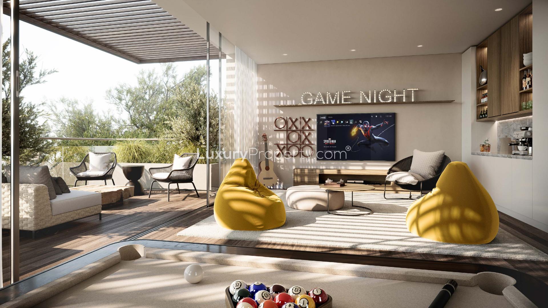 Luxurious living room in Tilal Al Ghaf villa with pool view and modern decor