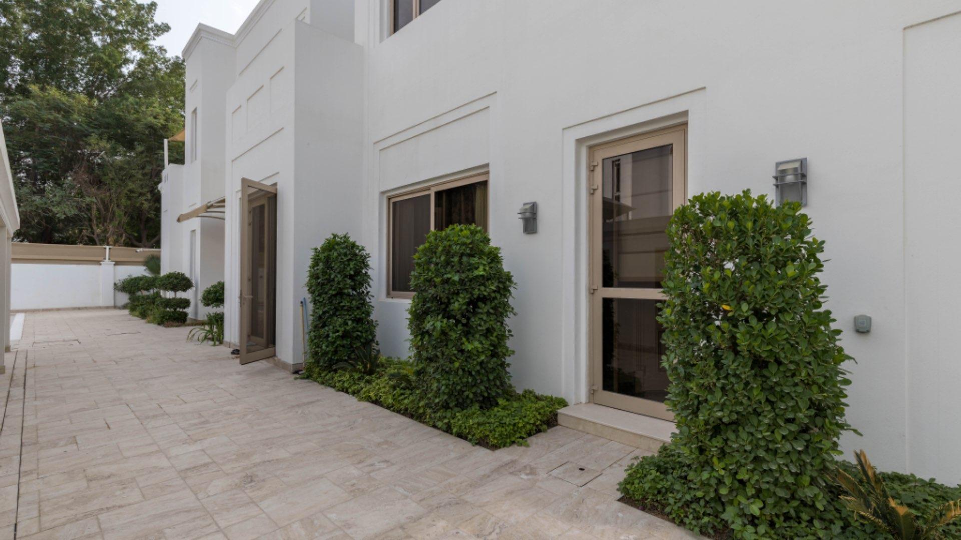 "Elegant pool surrounded by lush greenery at Al Barari villa for sale, 7 bedrooms.",Exclusive Al Barari villa entrance with lush greenery and modern design for sale