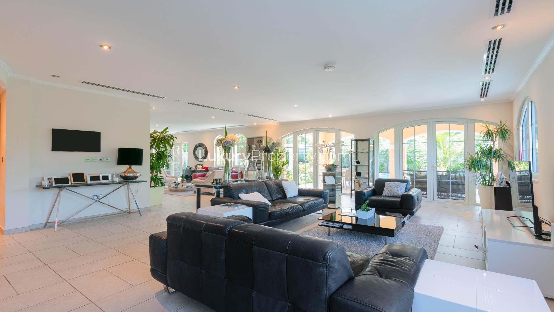 Spacious living room in Jumeirah Park villa with modern furnishings and garden view