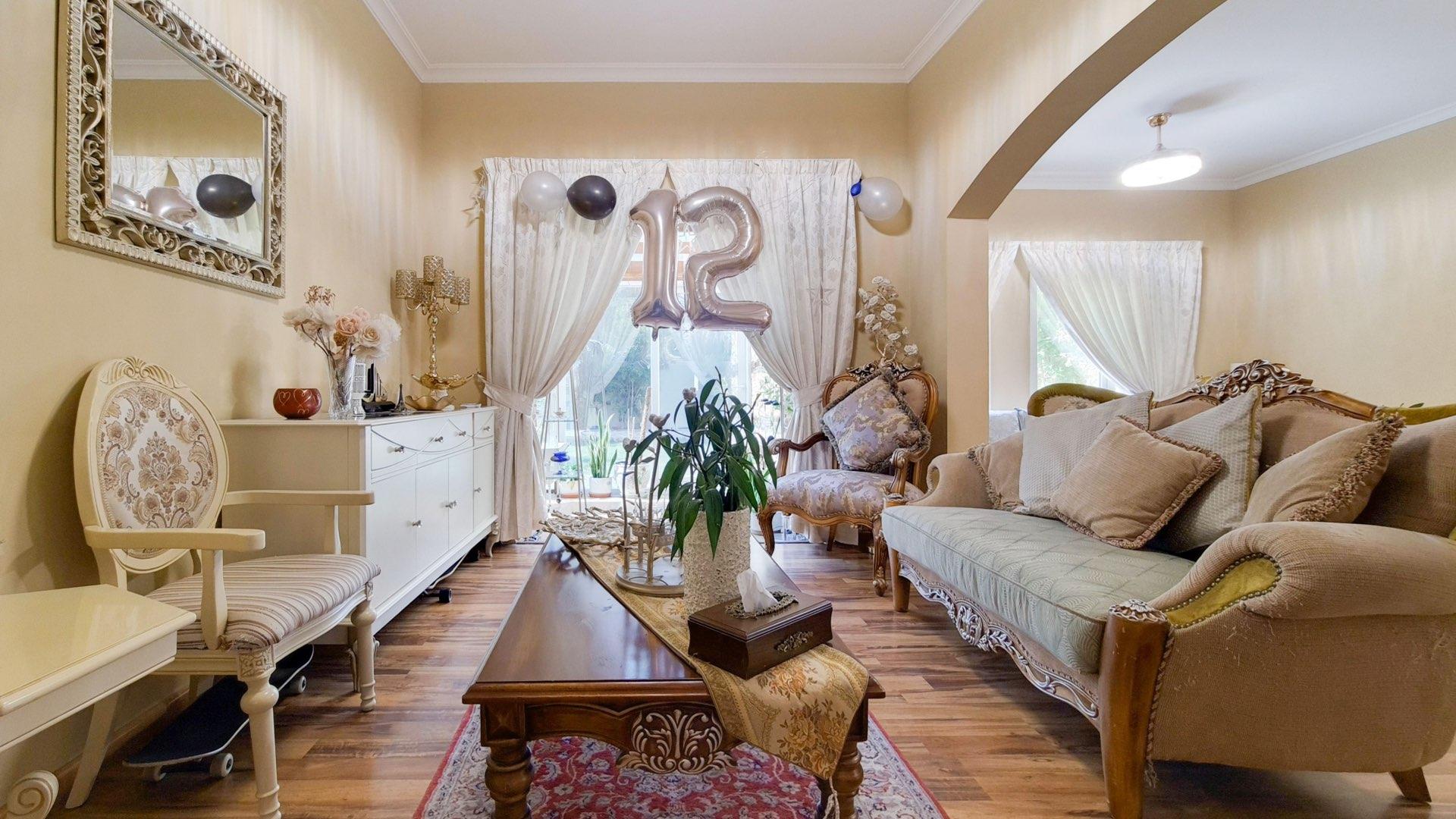 Upgraded 5-bedroom villa exterior in Meadows 3, featuring spacious lawn and modern design