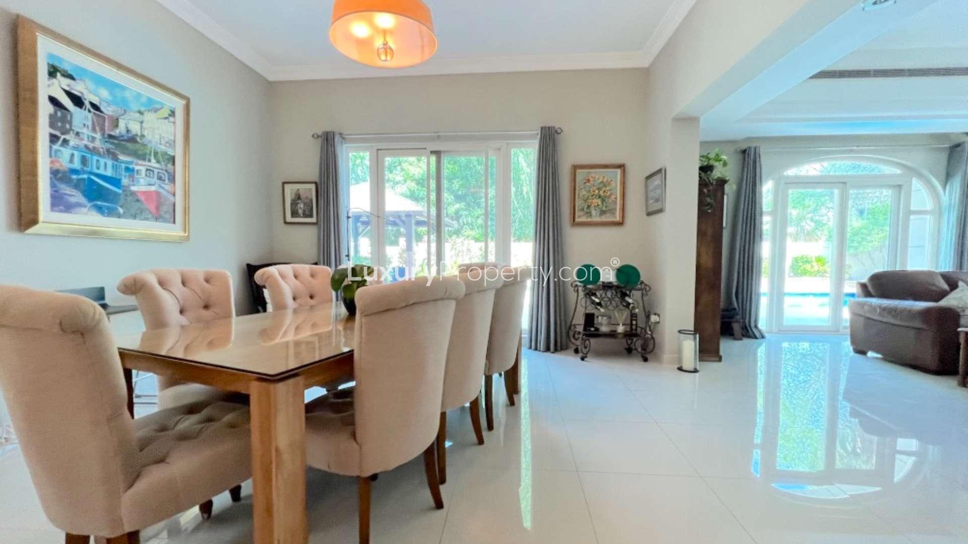 "Elegant dining area in upgraded C1 villa, Victory Heights, Dubai Sports City, for sale.",Dining area in upgraded C1 villa, Victory Heights, Dubai Sports City, with pool view