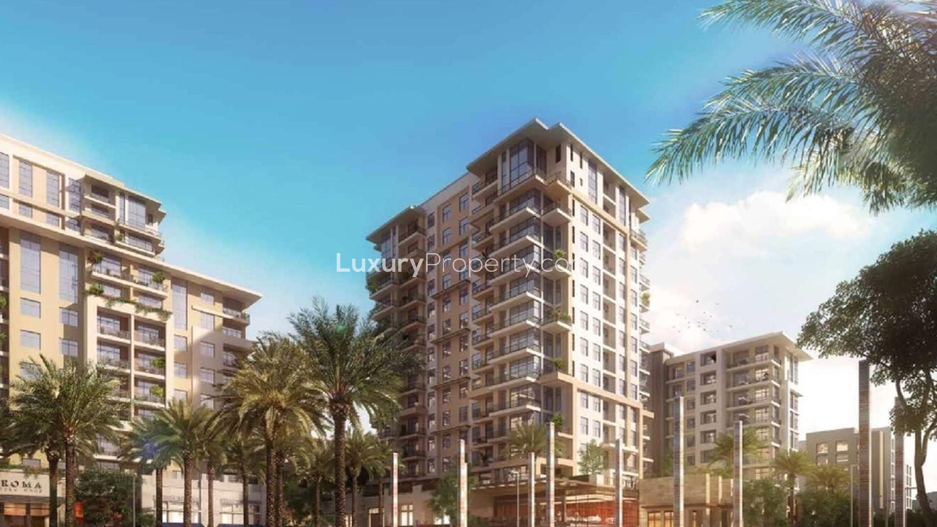 Exterior view of Jenna Apartments, Dubai Town Square, with palm-lined street and shops