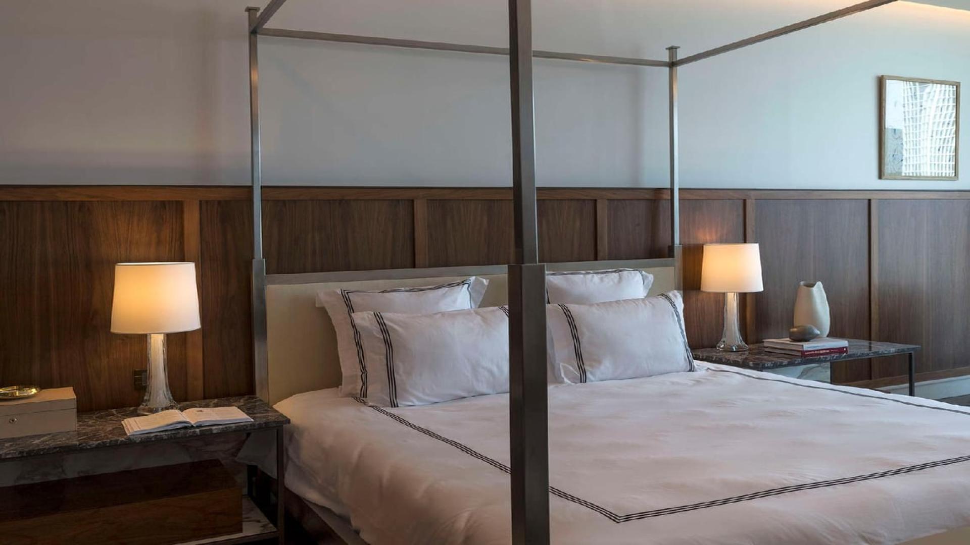 "Elegant dining area with city skyline view in Dorchester Collection penthouse, Business Bay.",Luxurious bedroom in triplex penthouse, Dorchester Collection, Business Bay, Dubai