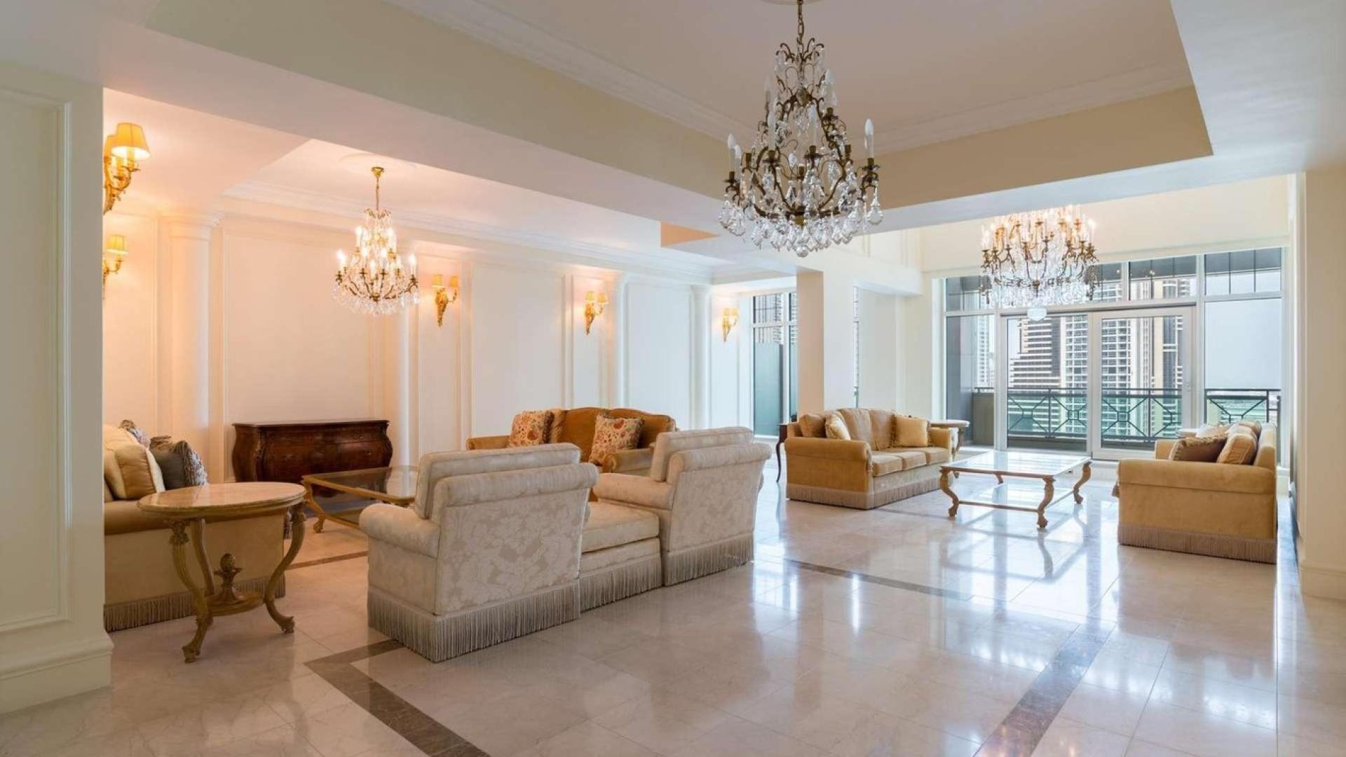 Luxurious living room in Al Anbar Tower penthouse, Dubai Marina with elegant chandeliers
