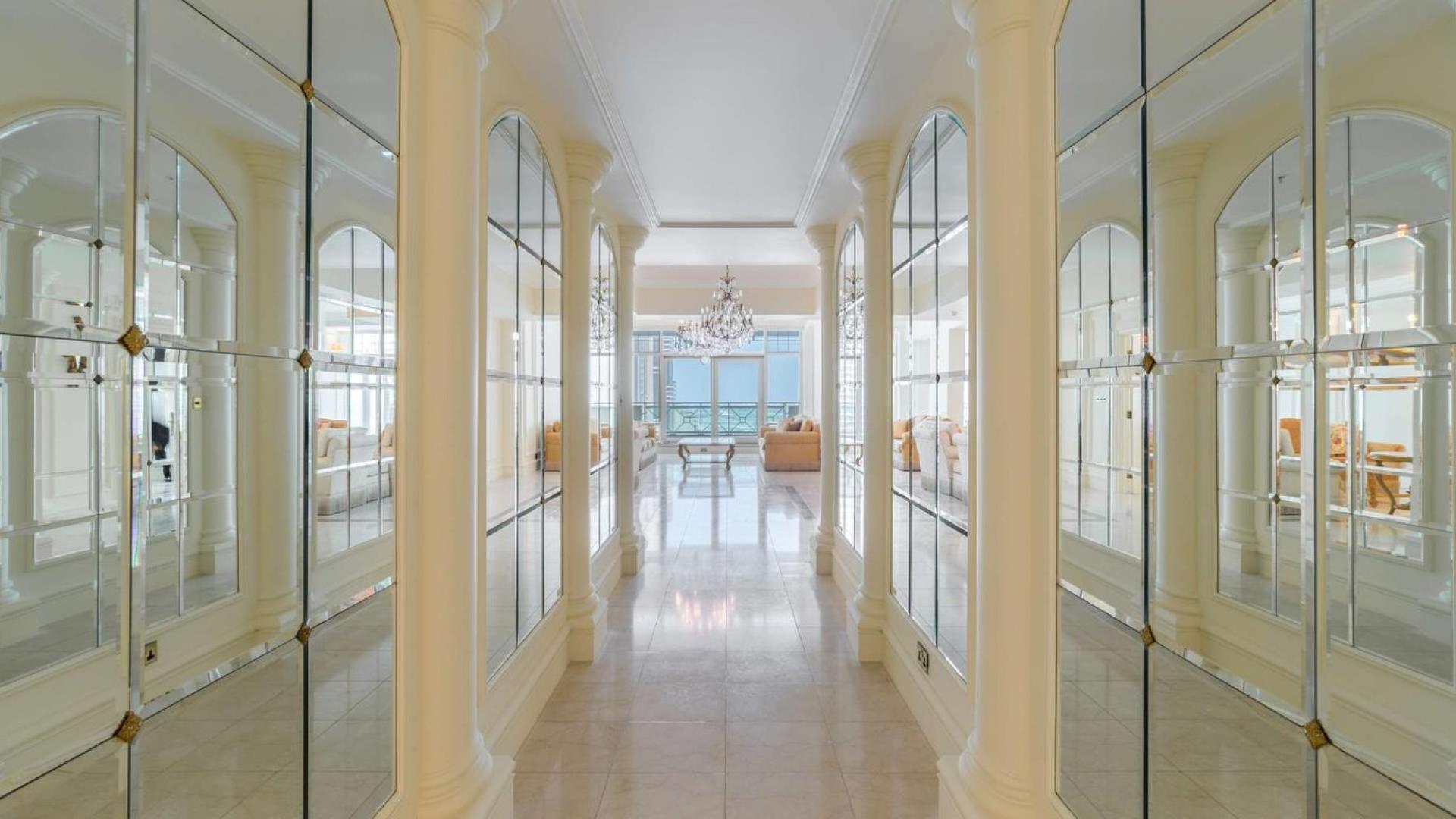 "Stunning view from duplex penthouse balcony in Al Anbar Tower, Dubai Marina.",Luxurious hallway with mirrored walls in Dubai Marina penthouse, Al Anbar Tower