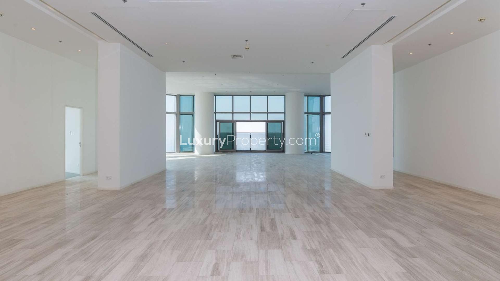 Penthouse interior with floor-to-ceiling windows offering panoramic views of Dubai, D1 Tower