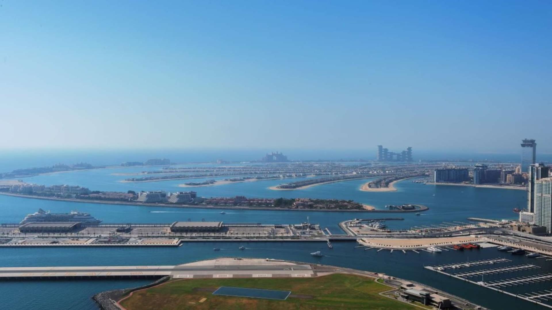 Duplex penthouse interior with ocean views, featuring modern staircase and expansive windows, 1 JBR