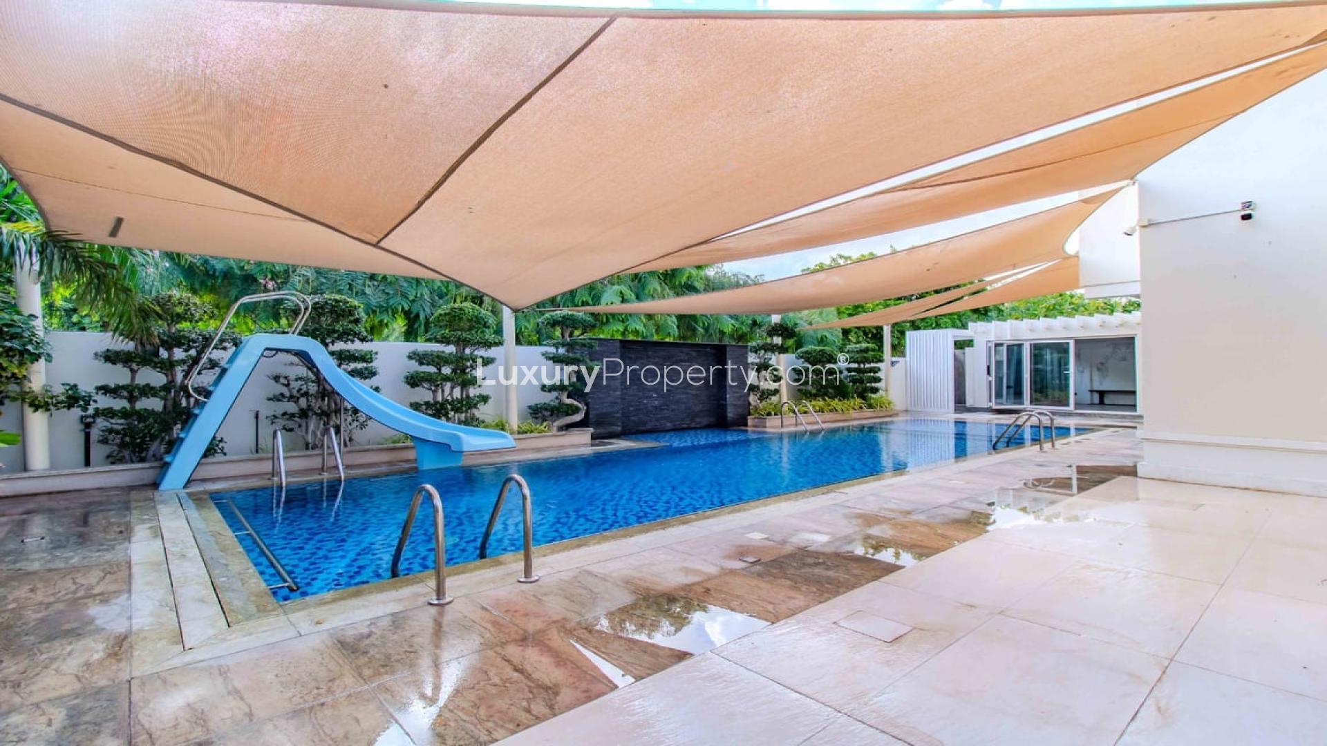 Outdoor pool with slide at 5-bedroom villa in Rosa, Arabian Ranches 2