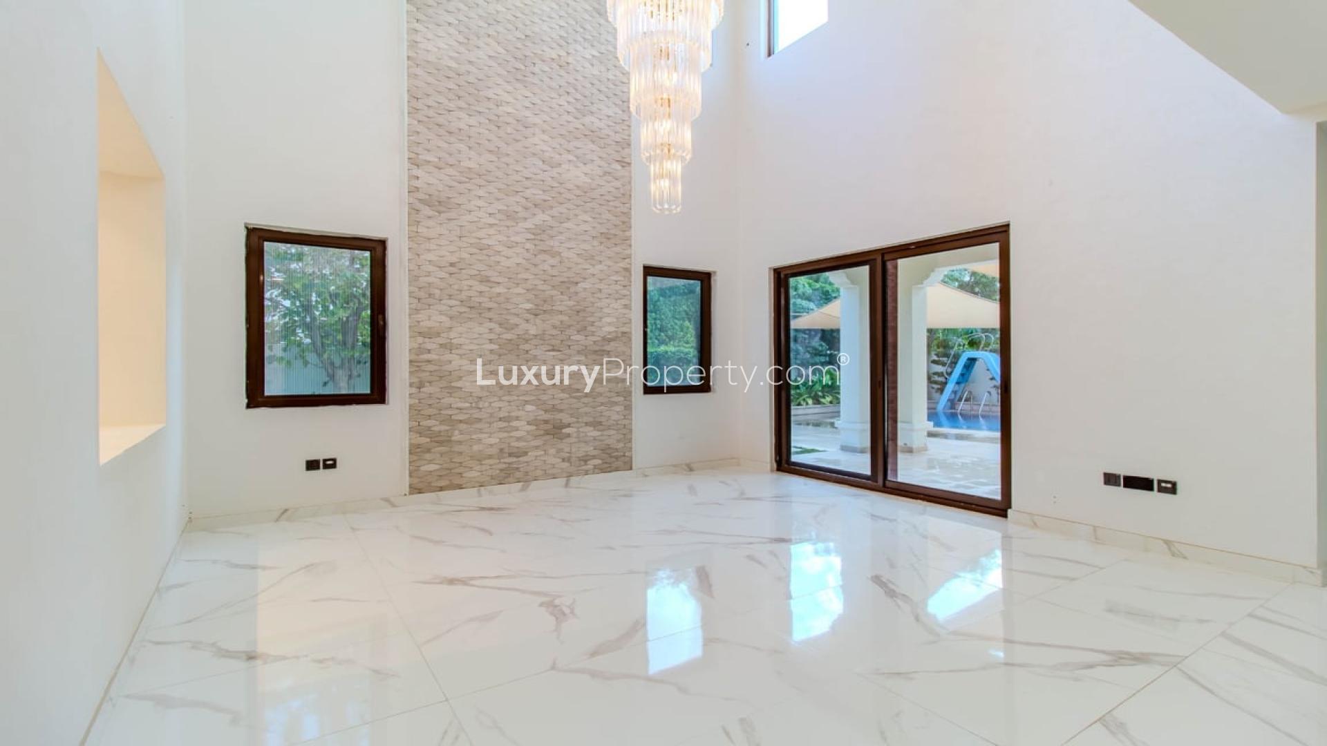 "Stunning 5-bedroom villa exterior in Rosa, Arabian Ranches 2 for sale.",Spacious living area with elegant chandelier in Rosa, Arabian Ranches 2 villa for sale