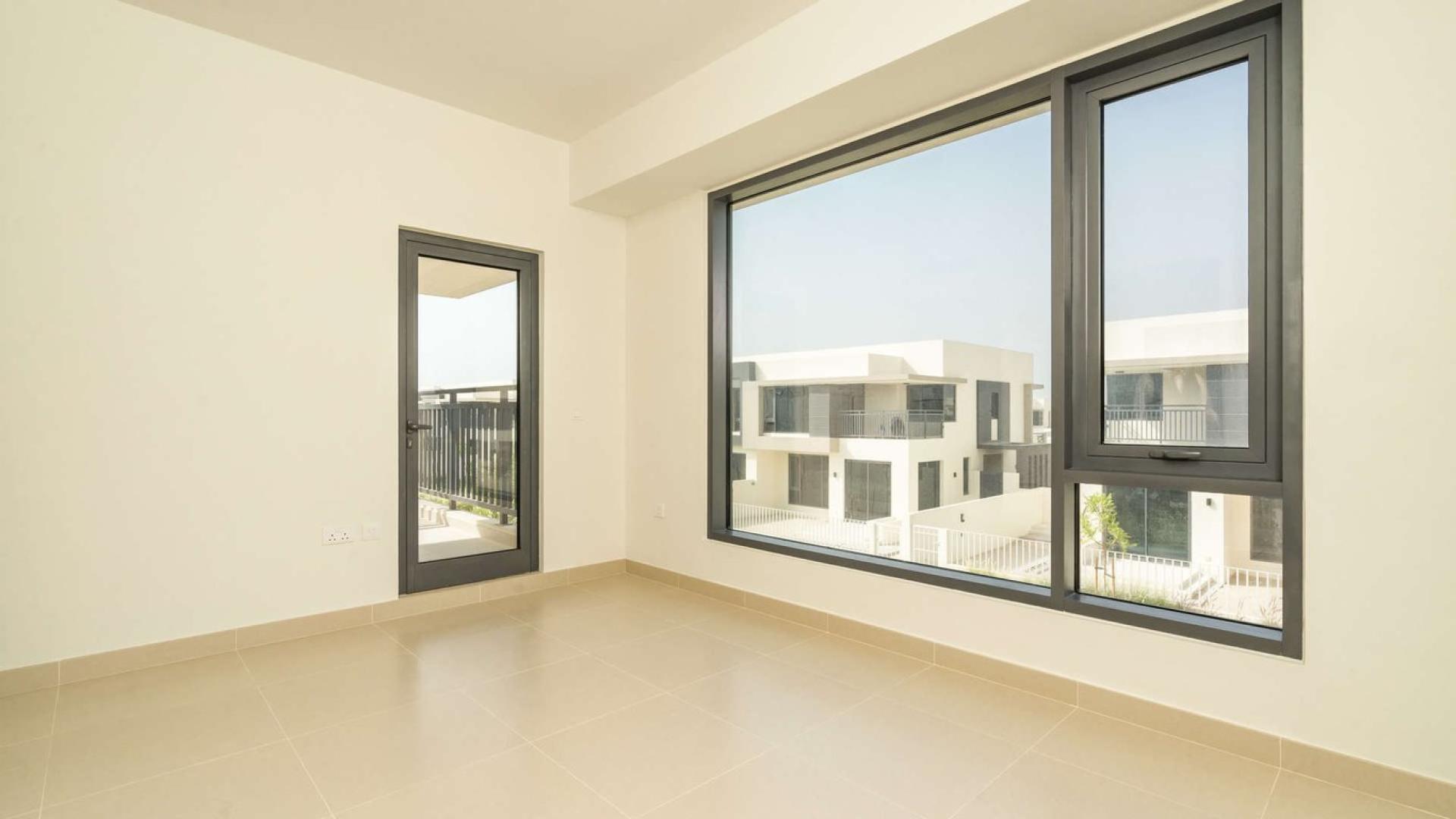 Modern kitchen and staircase in Maple Villa, Dubai Hills Estate; spacious and bright interior