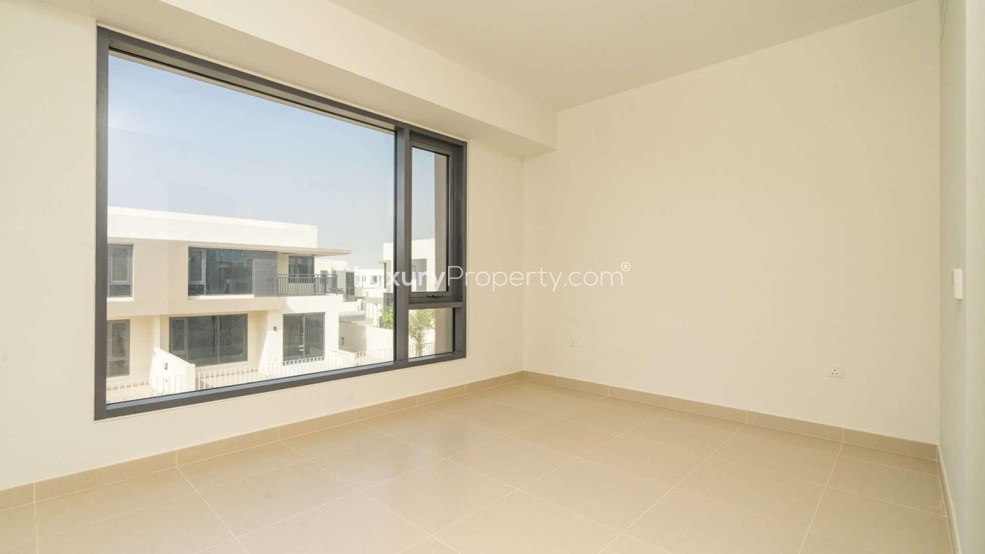 Empty room with large windows in Maple Villa, Dubai Hills Estate, available for rent