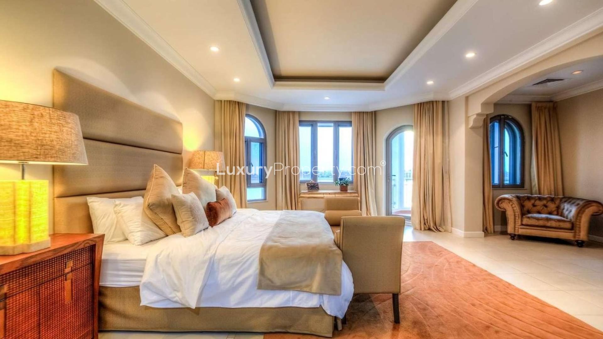 Luxurious bedroom in Palm Jumeirah villa with elegant furnishings and large windows
