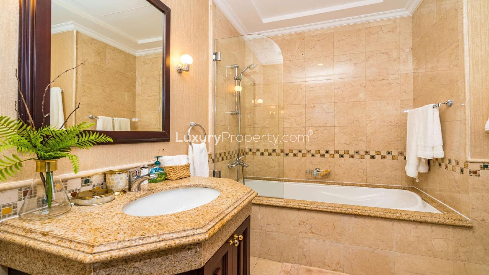Luxurious bathroom in Palm Jumeirah villa with elegant fixtures and marble finish