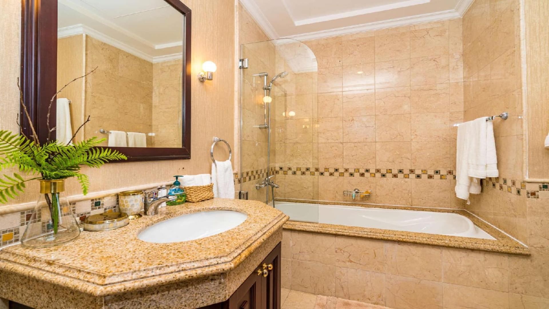 Luxurious bathroom in Palm Jumeirah villa with elegant fixtures and marble finish