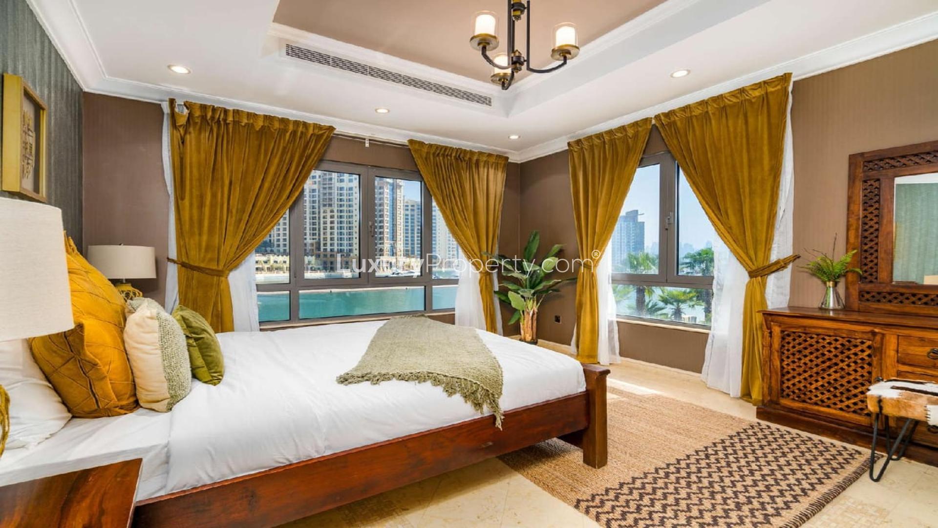 Luxurious bedroom in Palm Jumeirah villa with elegant decor and large windows
