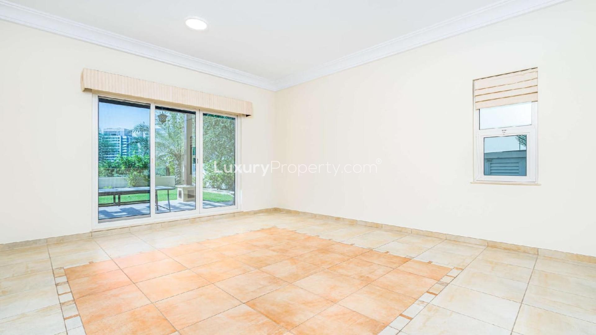 Spacious living room with garden view in Victory Heights villa, Dubai Sports City