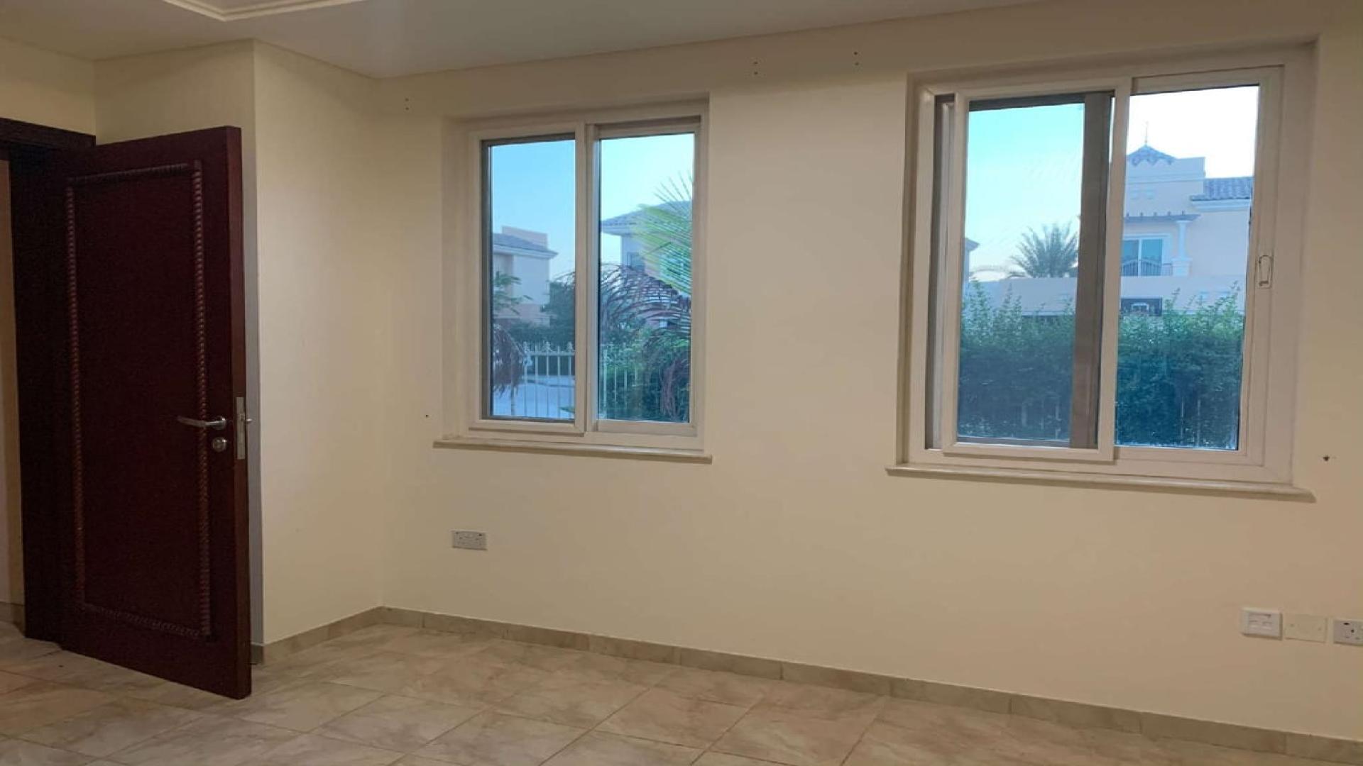 5-bedroom villa exterior in Victory Heights, Dubai, with lush greenery and charming architecture