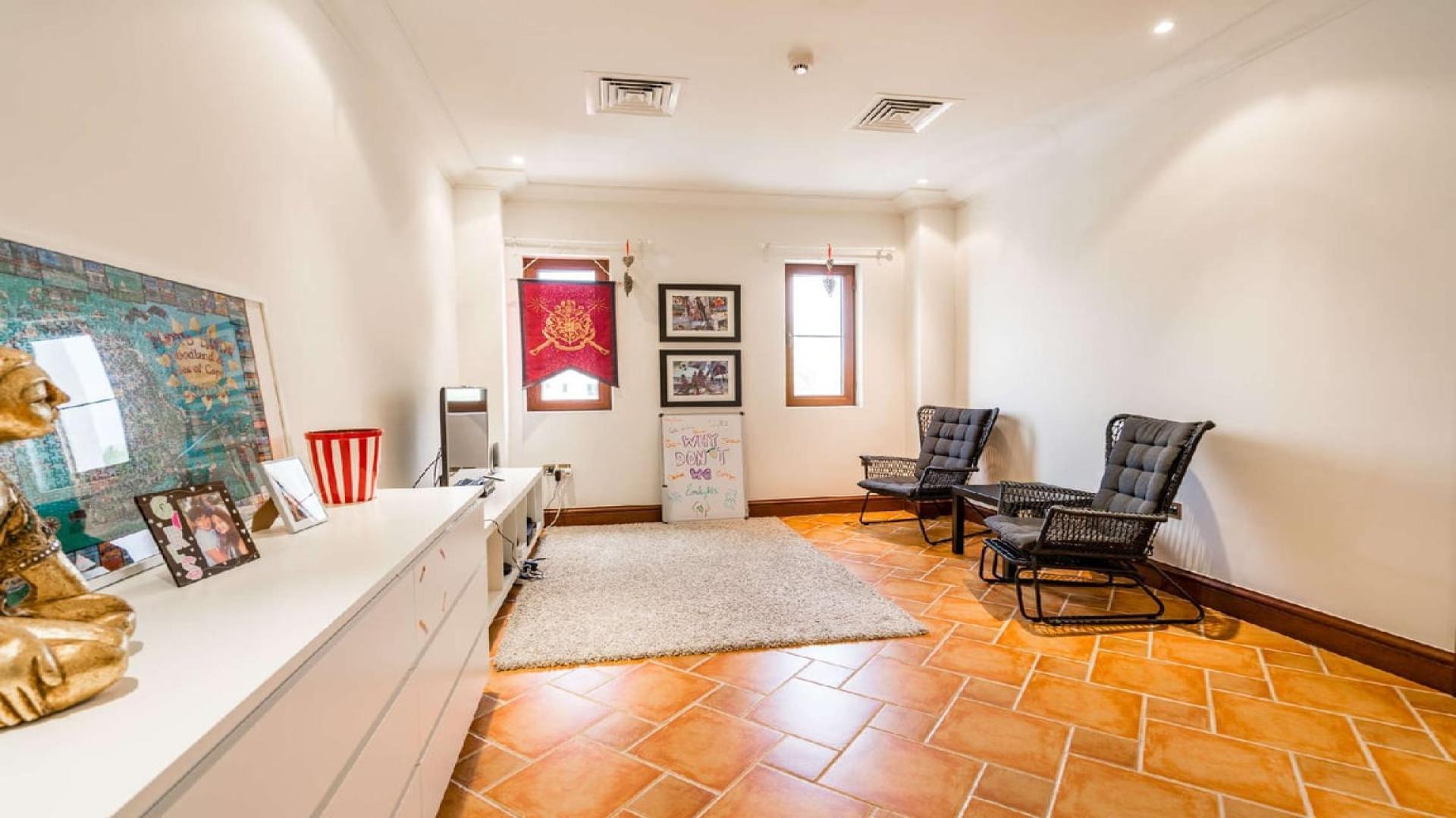 "Bright living area in upgraded Girona-style villa, Jumeirah Golf Estates, with modern decor.","Poolside view of lush greenery at Girona-style villa, Jumeirah Golf Estates, Earth community.","Balcony view of lush golf course at Girona-style villa in Jumeirah Golf Estates.",Upgraded Girona-style villa entrance with terracotta tiles, Jumeirah Golf Estates, Earth community