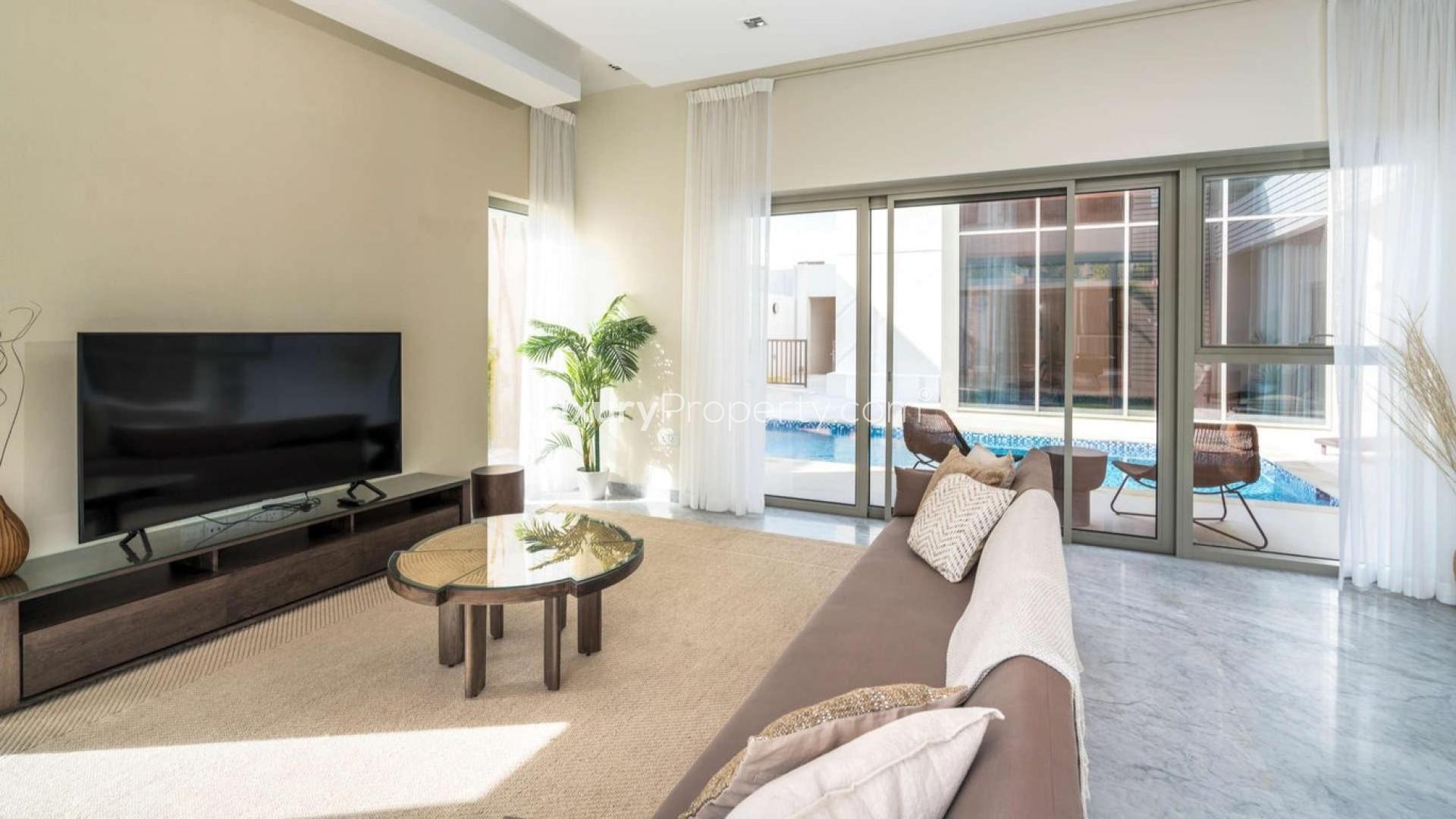Luxury furnished living room in District One villa, Dubai, with modern decor and pool view