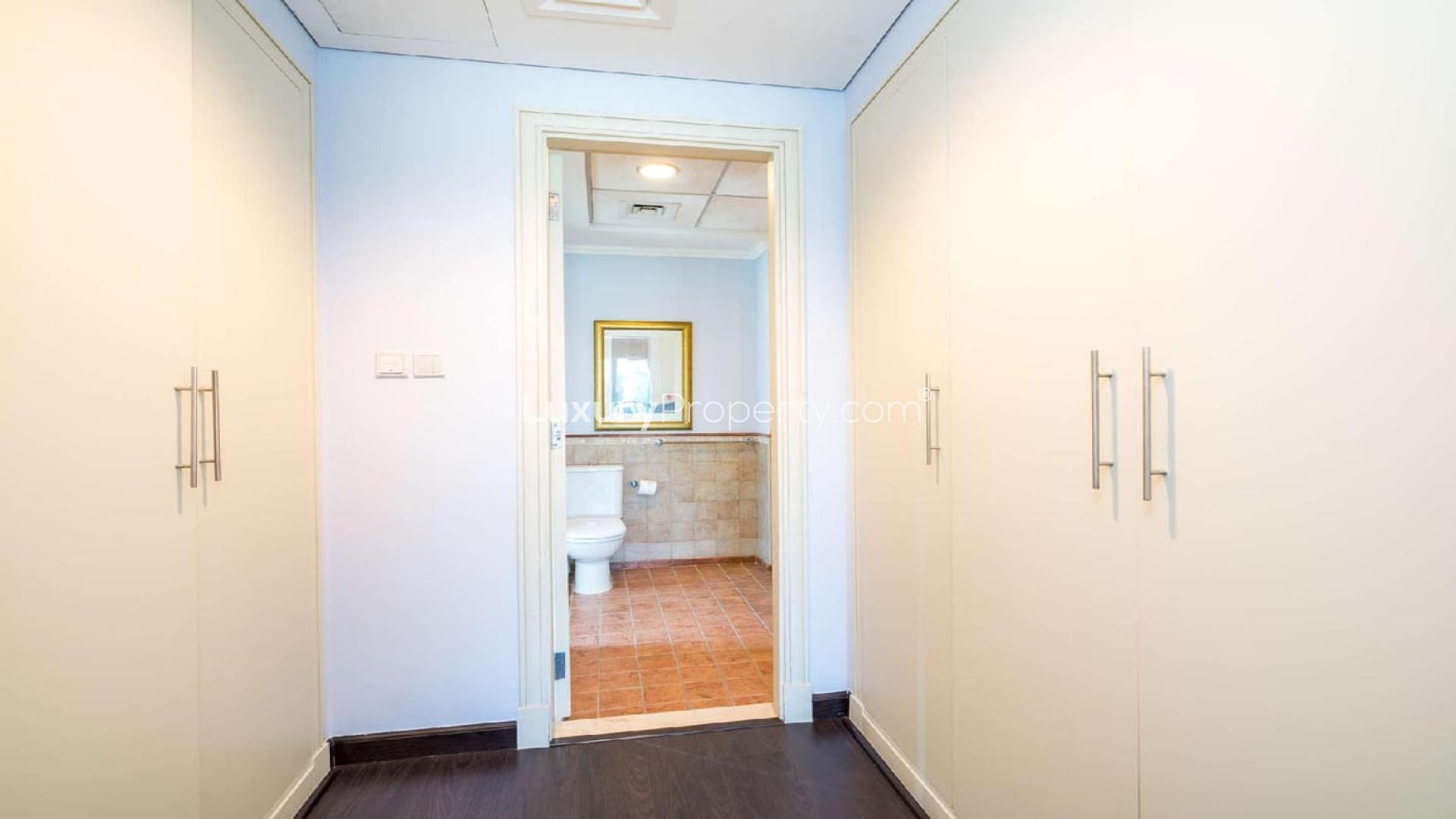 Spacious living room in upgraded 5-bedroom villa, Victory Heights, Dubai, with garden view