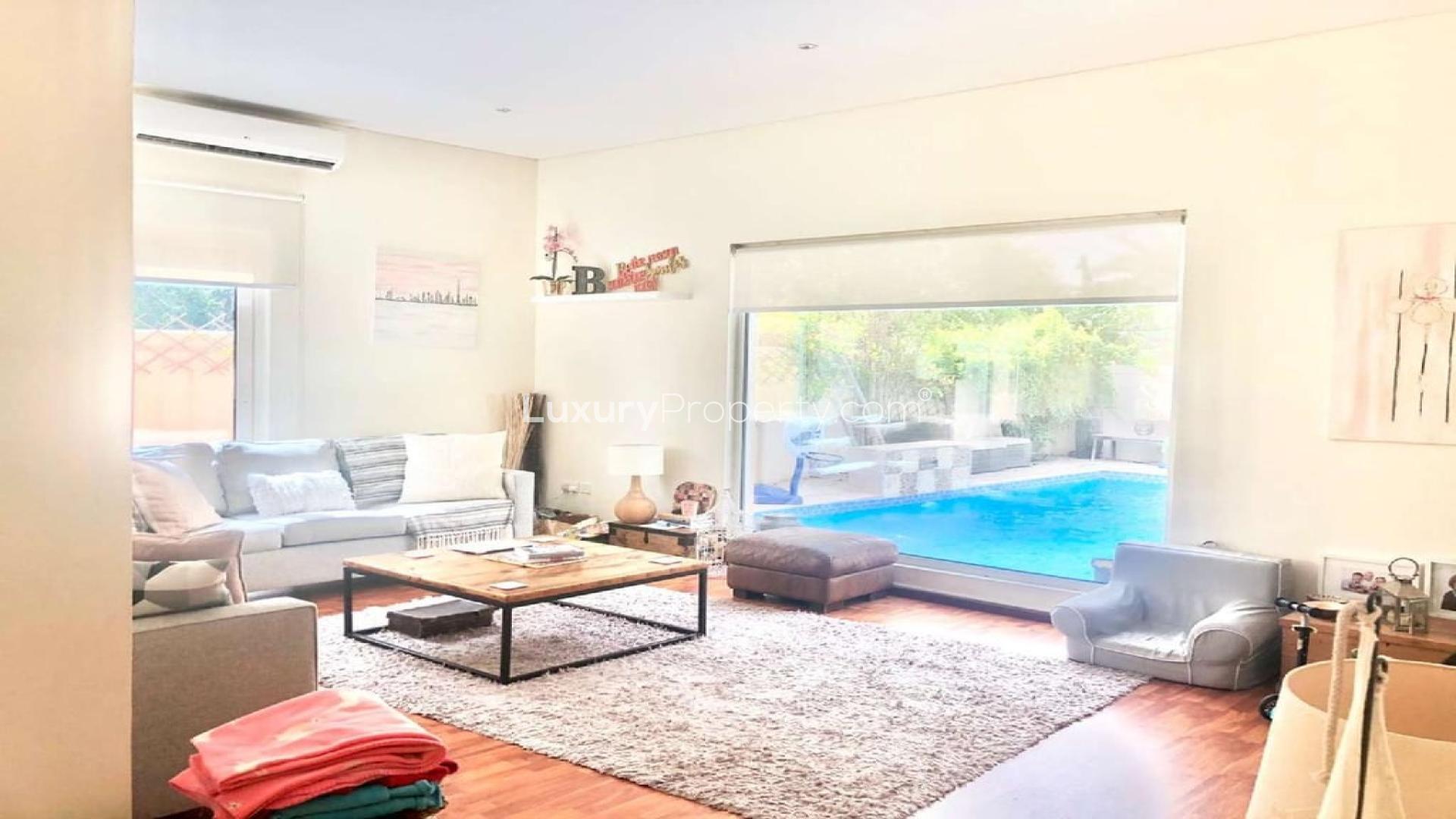 Living room view of upgraded villa with private pool in Victory Heights, Dubai Sports City