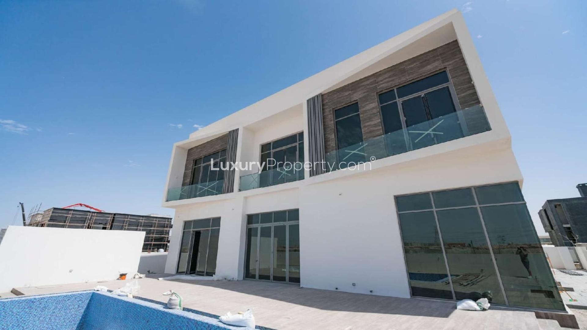 Modern villa interior in Dubai Hills Estate, featuring spacious open-plan layout and large windows