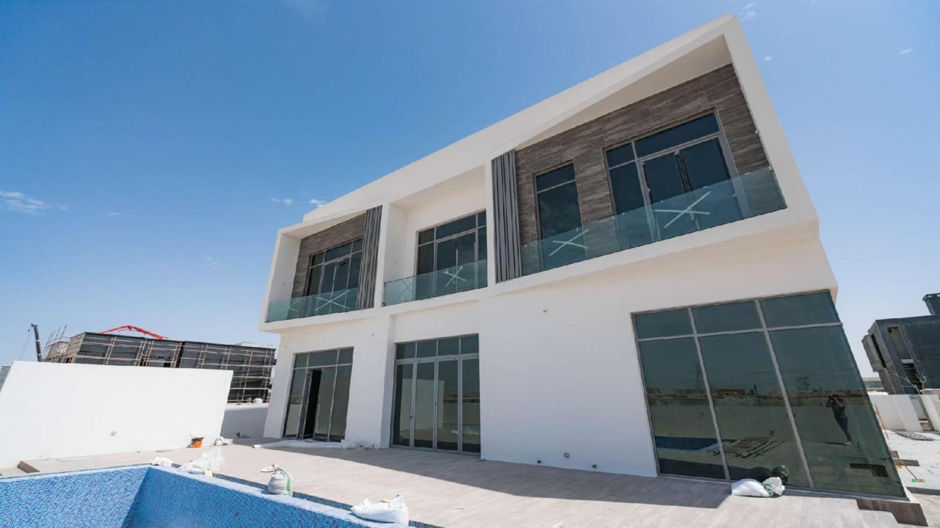 Modern villa interior in Dubai Hills Estate, featuring spacious open-plan layout and large windows