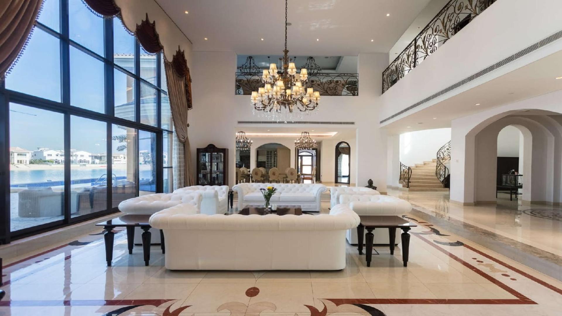 N/A,Luxurious living room in 5-bedroom Palm Jumeirah villa with sea views and elegant decor