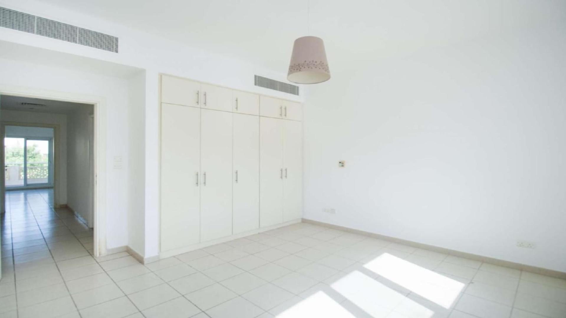 Bright living area in 5-bedroom villa, Meadows 2, with garden view and tiled flooring