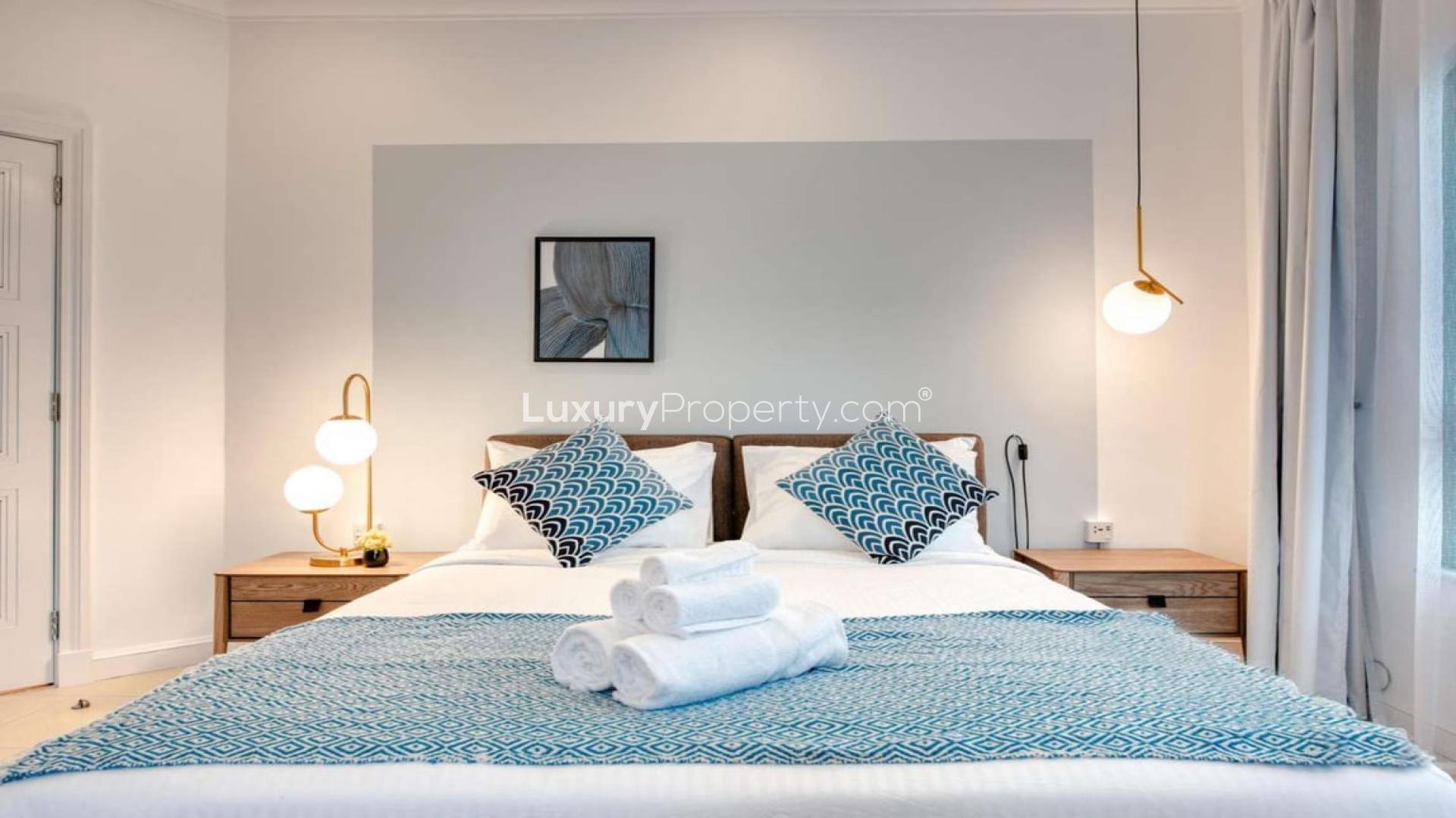 Luxurious 5-bedroom villa exterior in Palm Jumeirah, Garden Homes, with lush landscaping