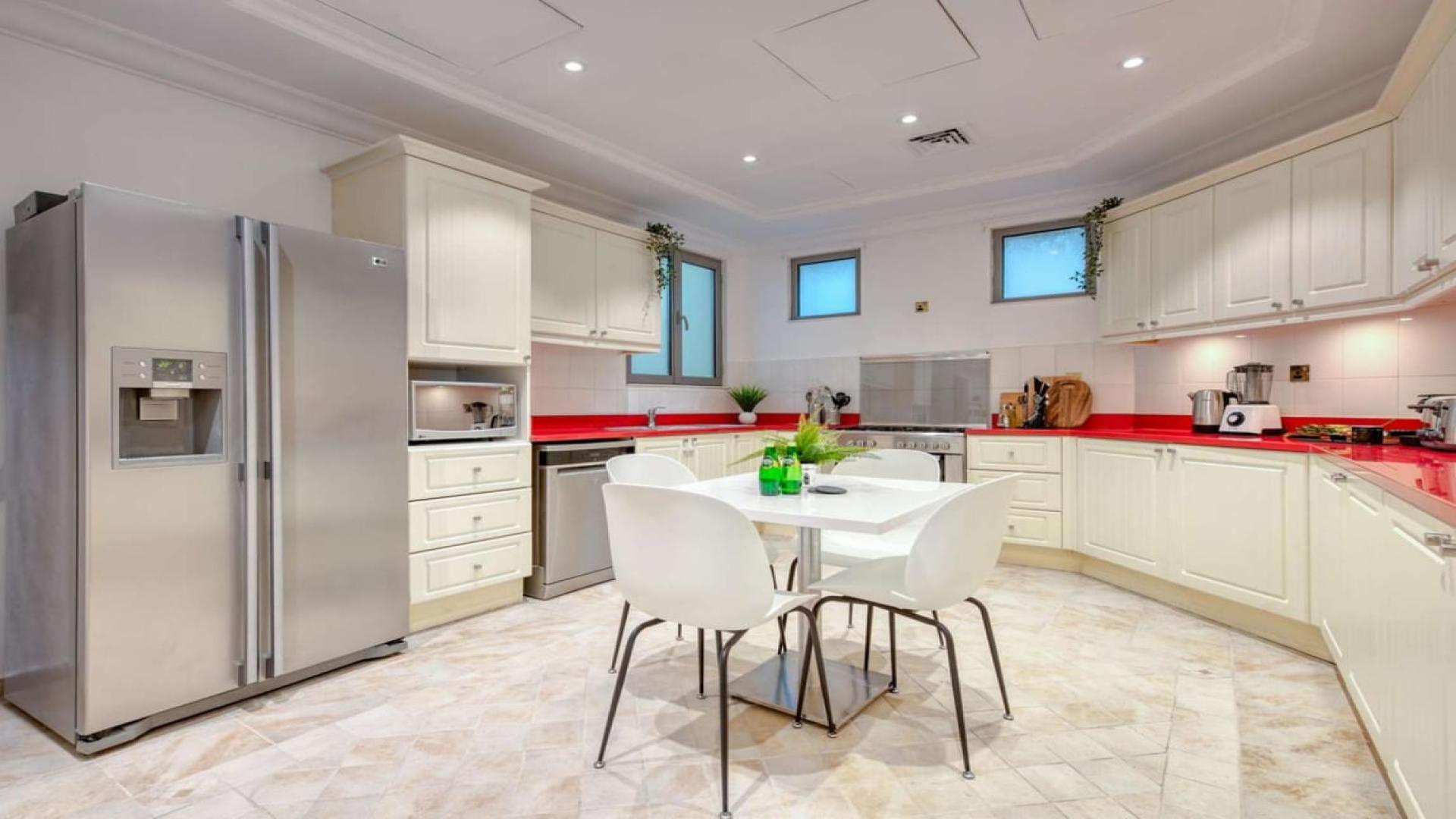 Luxurious living room in Palm Jumeirah villa with elegant decor and garden view