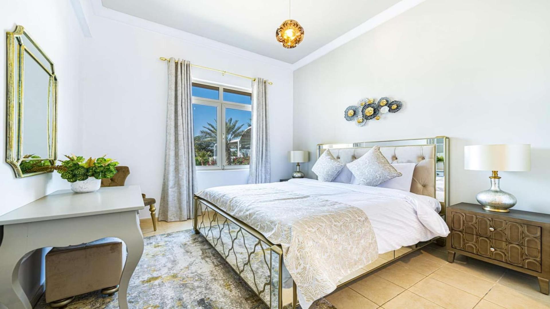 Elegant living room in fully furnished Jumeirah Islands villa, featuring garden view